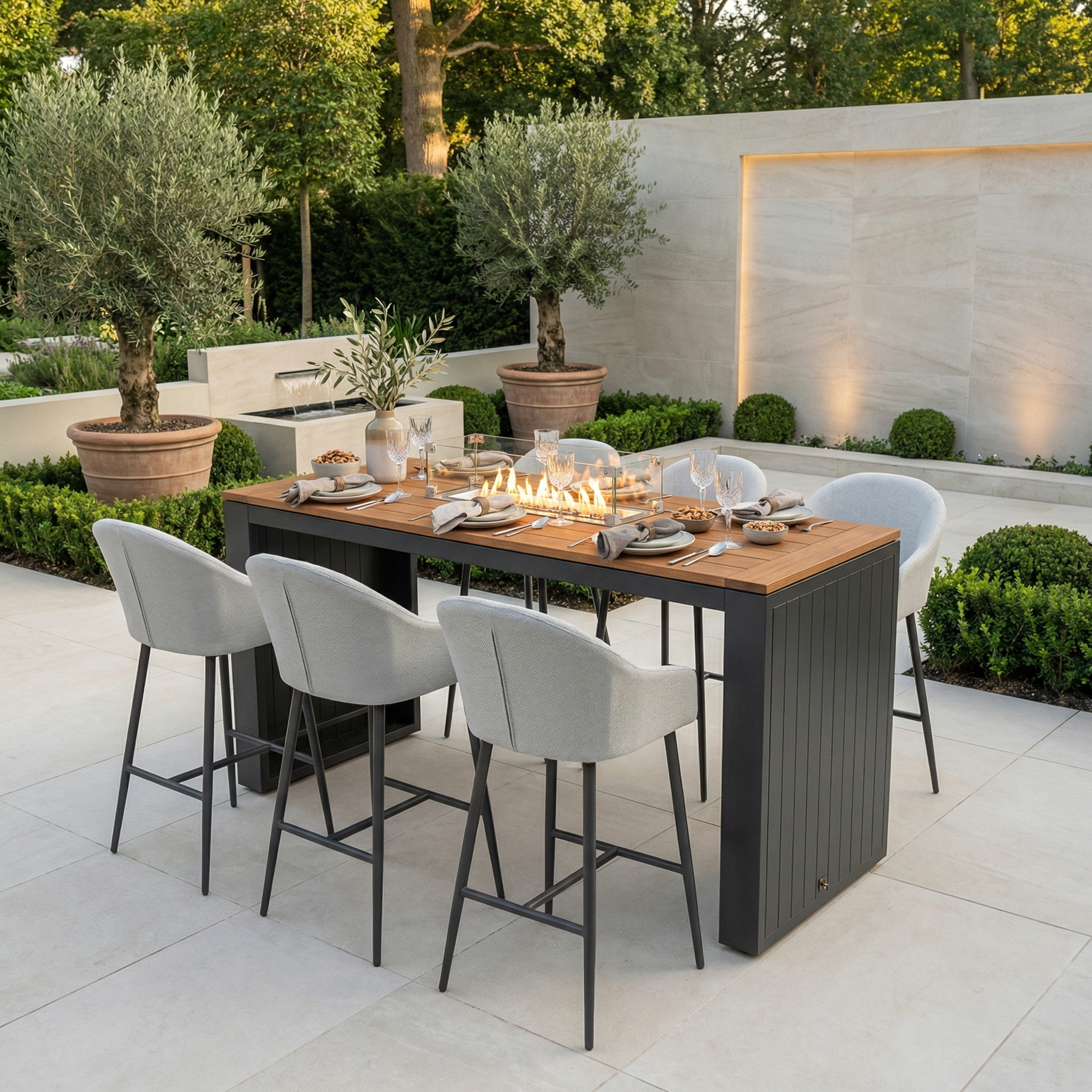 Luna 6 Seat Outdoor Fabric Teak Firepit Bar Set in Oyster Grey, with barstools around a teak topped bar table and a central firepit for summer entertaining.