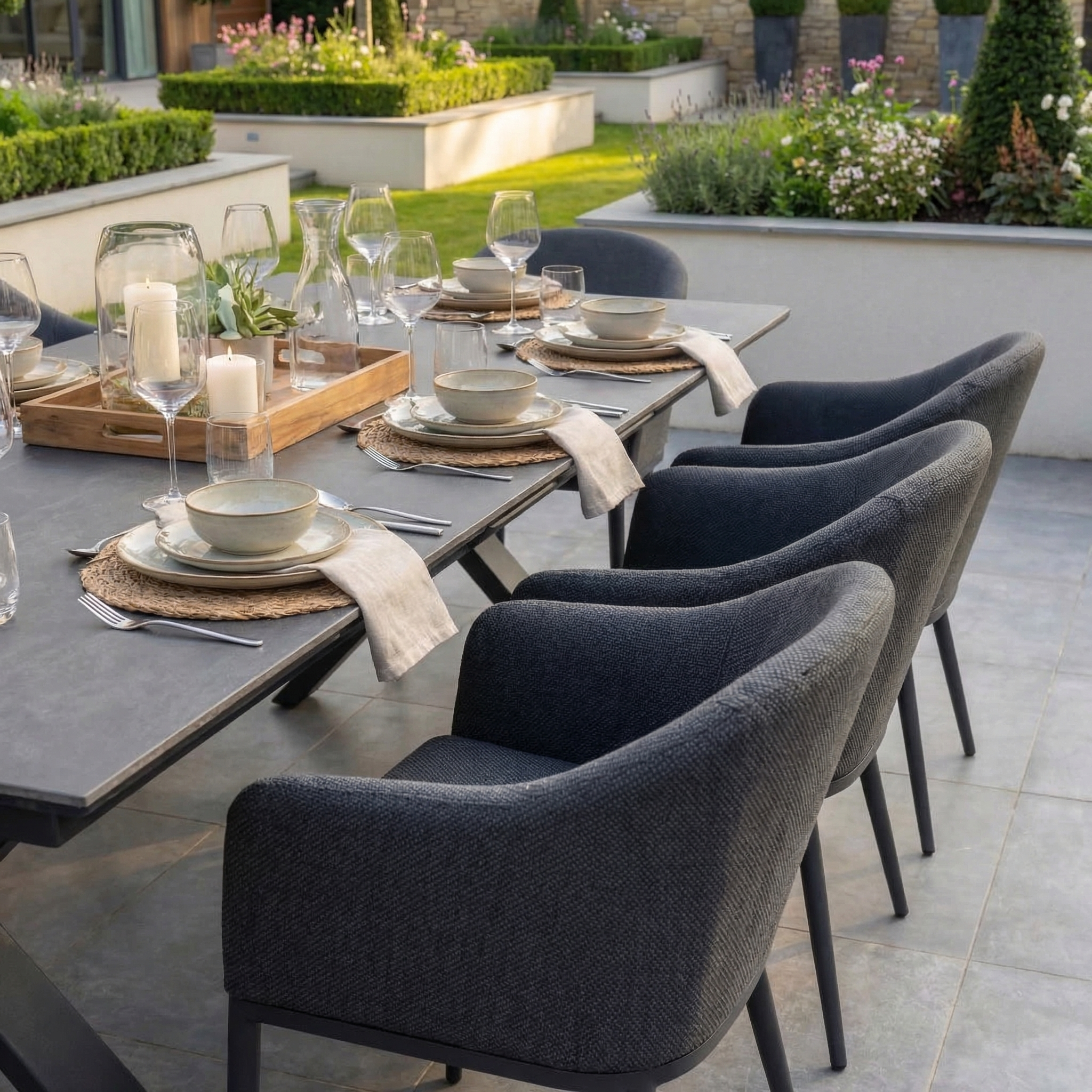 The Luna 8 Seat Outdoor Fabric Dining Set with Albatross Extending Table in Grey seats eight—perfect for stylish garden gatherings and outdoor dining.