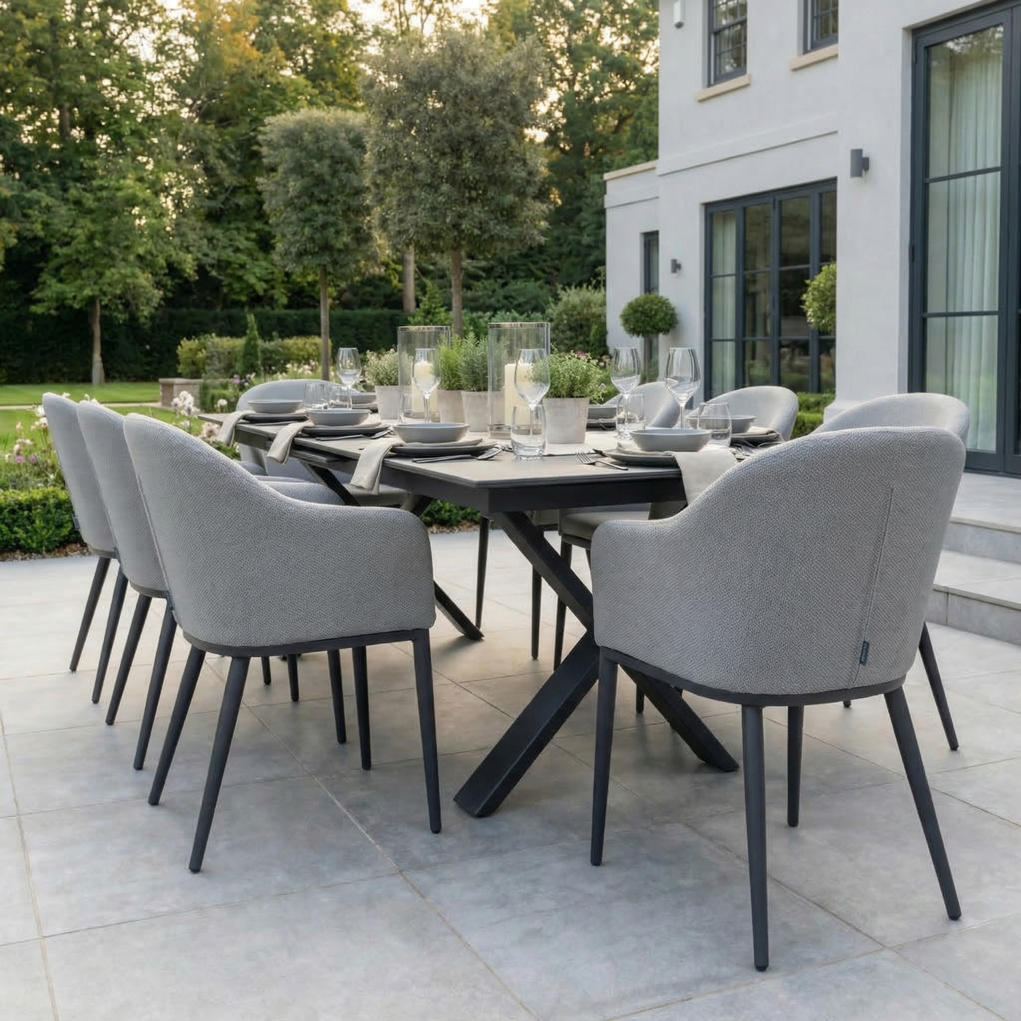 The Luna 8 Seat Outdoor Fabric Dining Set with Albatross Extending Table in Oyster Grey features eight cushioned chairs, creating an elegant patio dining space.