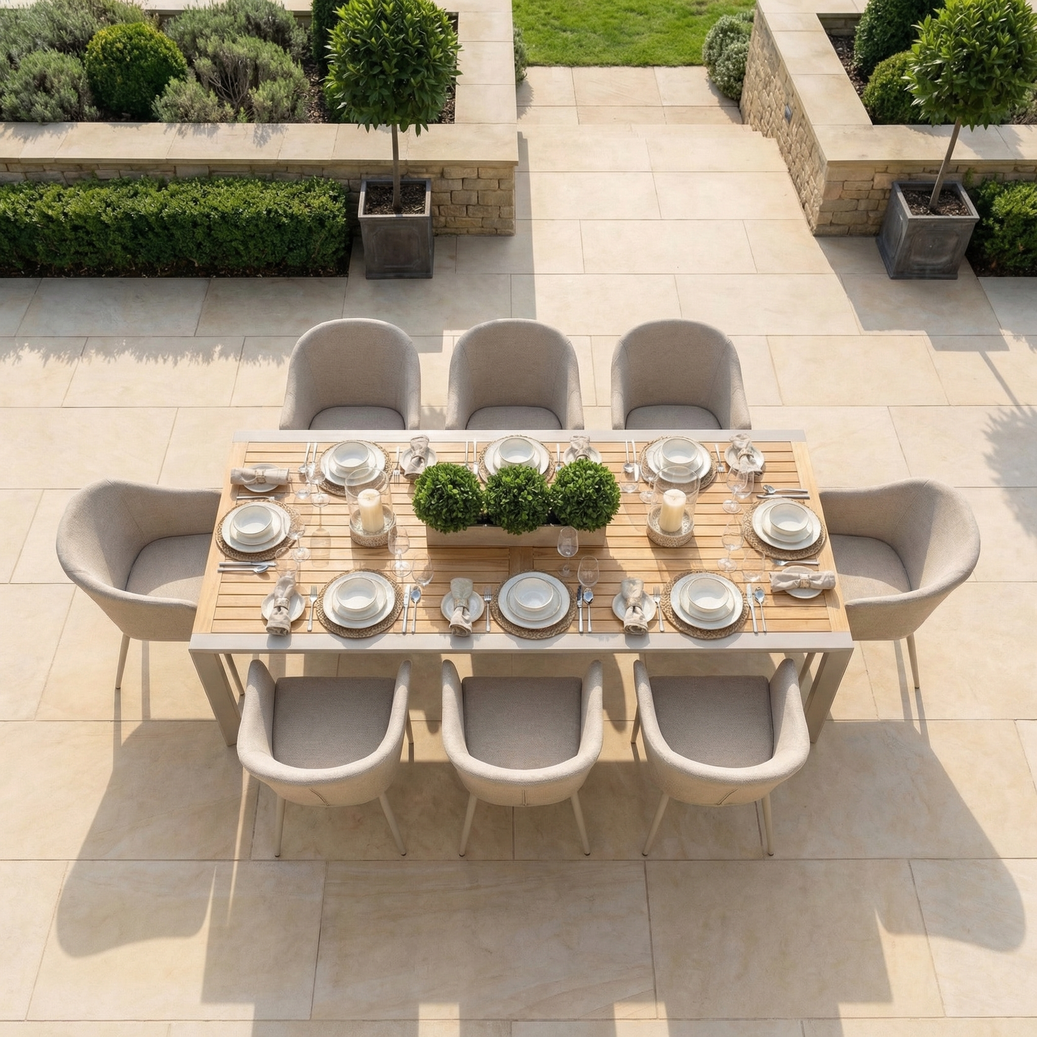 The Luna 8 Seat Outdoor Fabric Extending Teak Dining Set in Fawn features beige chairs and a chic centerpiece—ideal all-weather furniture for stylish al fresco gatherings.