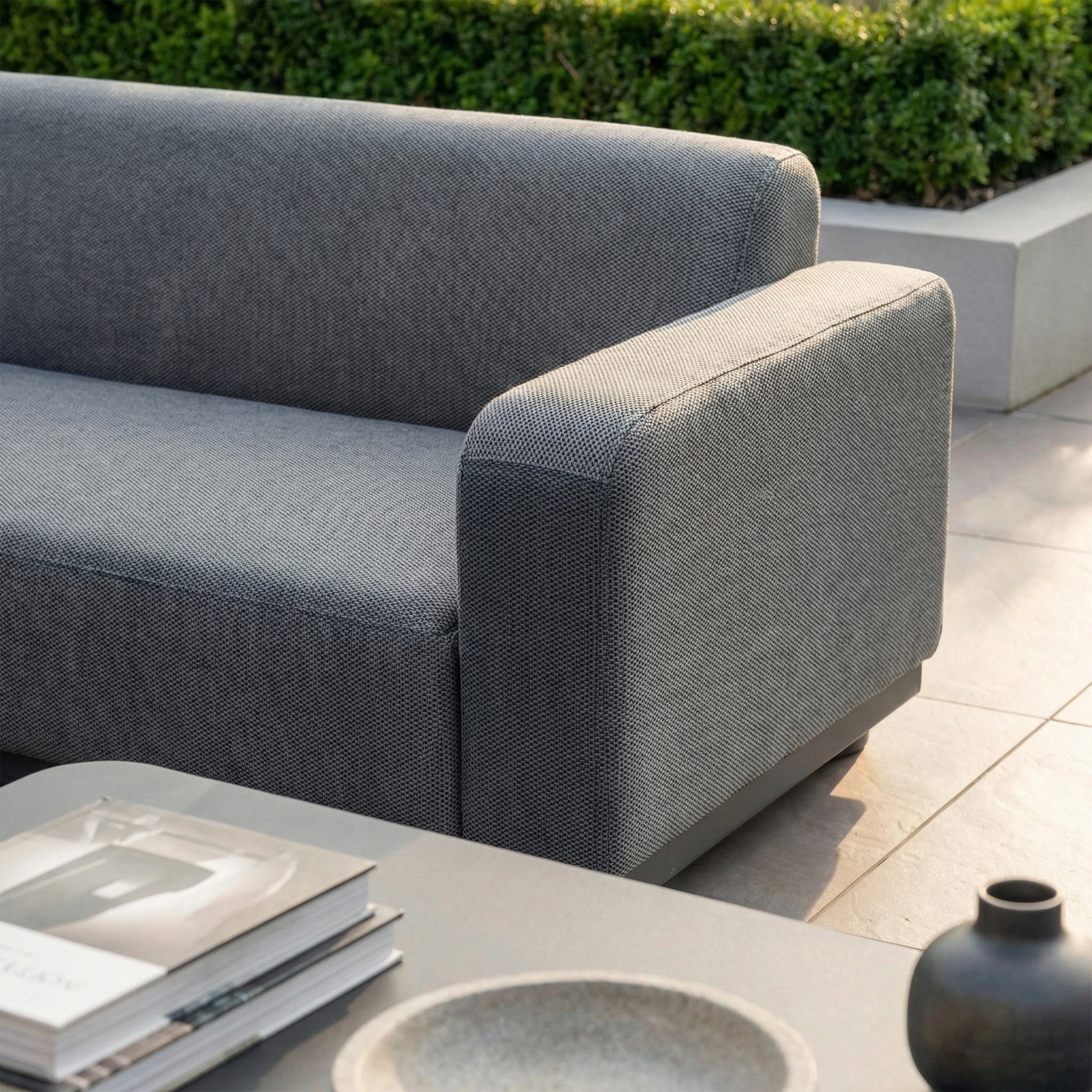 The Luna Outdoor Fabric Curved Corner Sofa Set with Altura Rising Table in Grey offers modern all-weather garden comfort, featuring a stylish sofa and table—ideal for patios and perfect for outdoor relaxation.