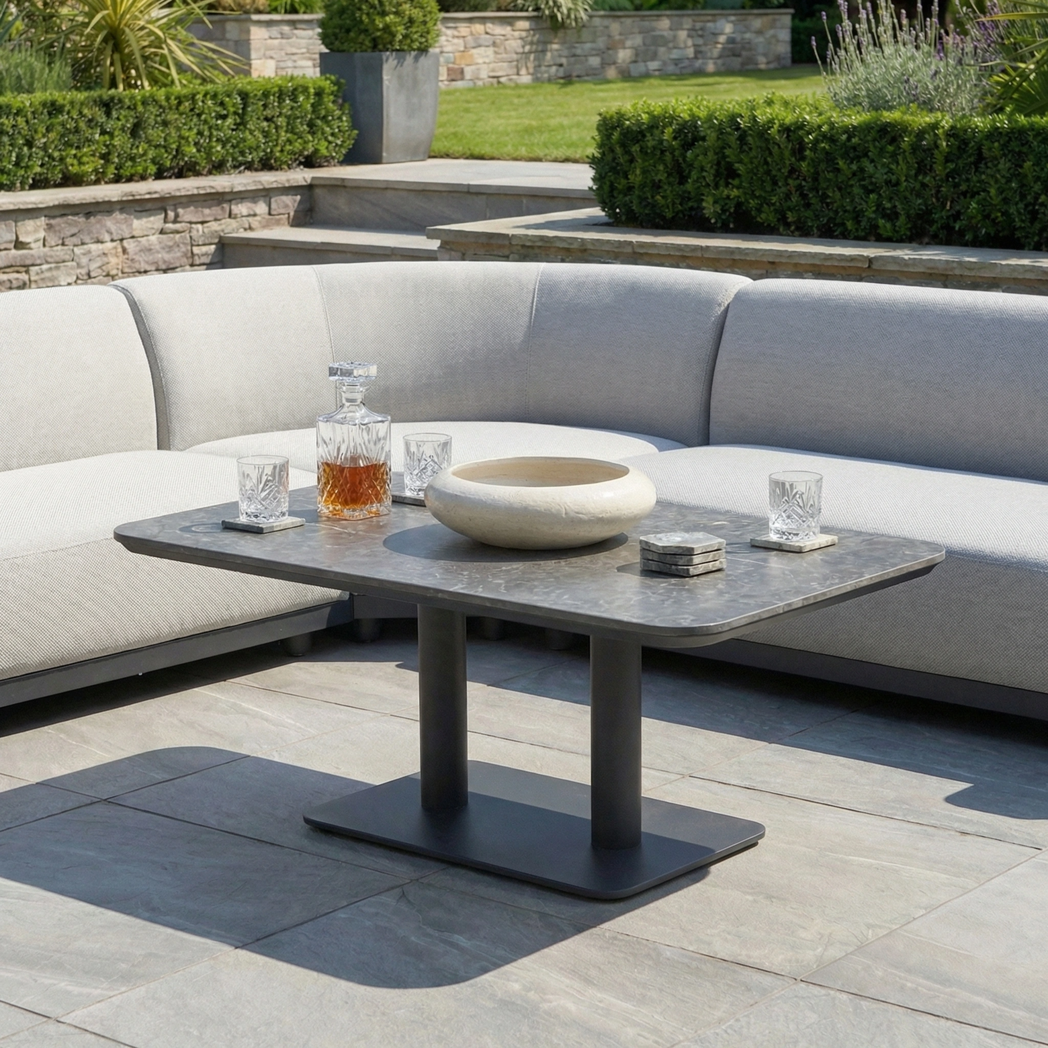 Relax in style on the Luna Outdoor Fabric Curved Corner Sofa Set with Altura Rising Table in Oyster Grey, perfect for modern patios and all-weather gatherings.