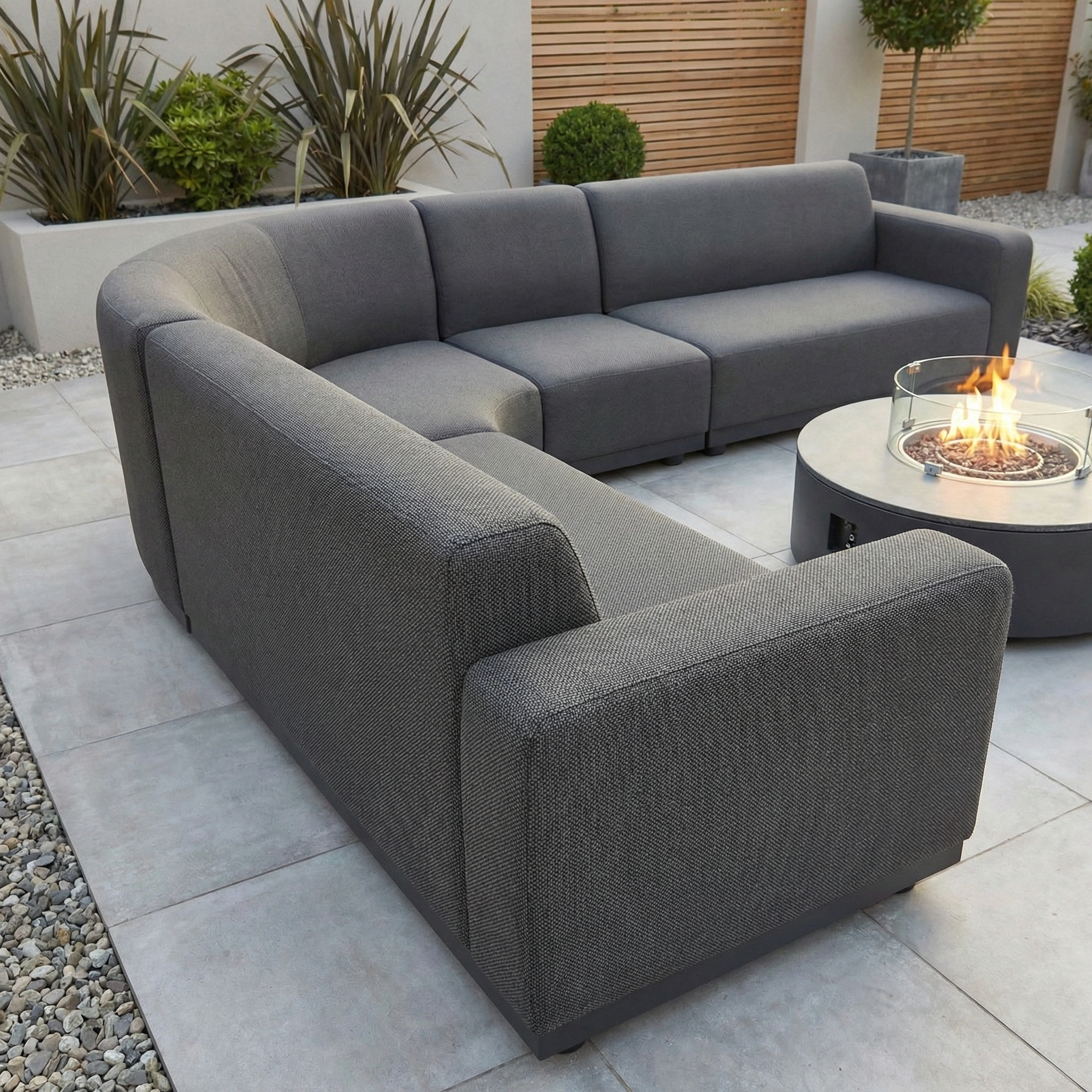 The Luna Outdoor Fabric Large Curved Corner Group Set with Round Firepit Coffee Table in Grey is perfect all-weather outdoor furniture for relaxing in style, featuring quick-dry cushions and modern design.
