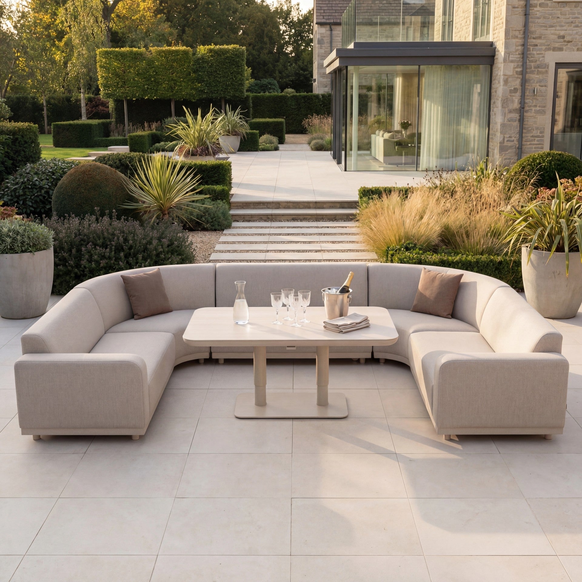 The Luna Outdoor Fabric Curved U-Shape Sofa Set with Altura Rising Table in Fawn features all-weather fabric, perfect for stylish garden patios and outdoor entertaining.