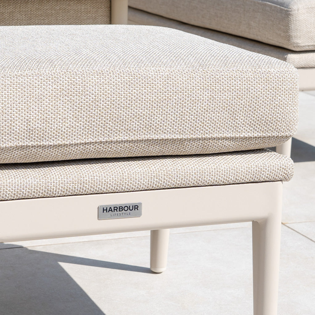 Close-up of a beige lounge chair cushion with a "Harbour Lifestyle" label and quick-dry foam for comfort. Pair with the Luna Stool in Fawn or any all-weather outdoor stool to complete your outdoor retreat.