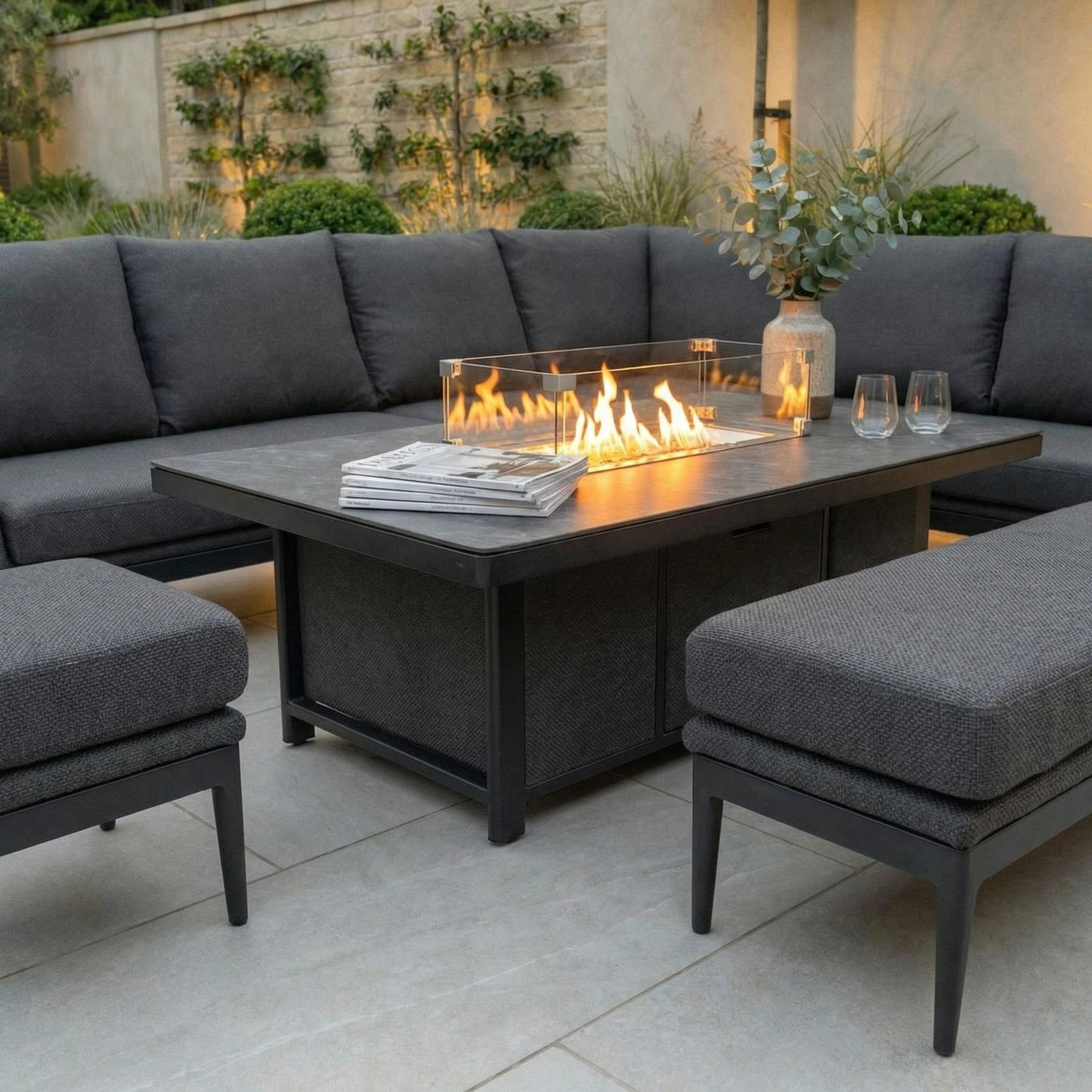Relax at dusk in style with the Luna Outdoor Fabric Rectangular Corner Dining Set (Right Hand) in grey, featuring a sleek rising firepit table—perfect for modern patios.