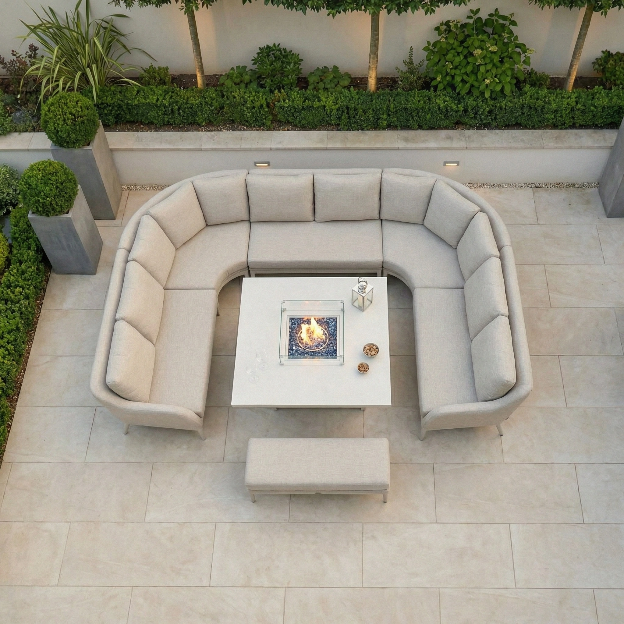 Outdoor patio featuring the Luna U-Shape Outdoor Fabric Corner Dining with Rising Table in Fawn, set against garden greenery.