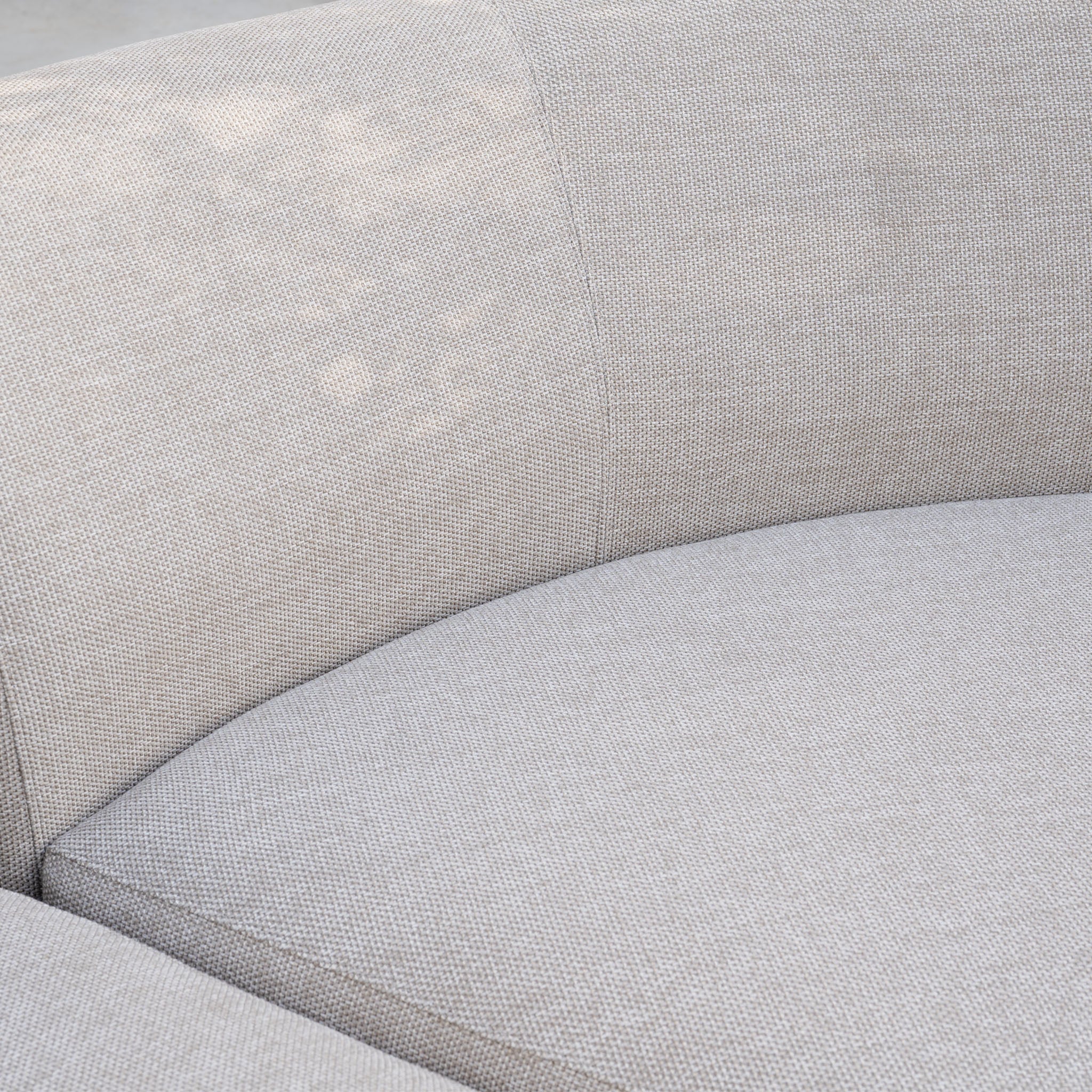 Close-up of the Luna Outdoor Fabric Curved U-Shape Sofa Set with Altura Rising Table in Fawn, featuring curved lines and textured fabric—ideal as an outdoor corner sofa set.
