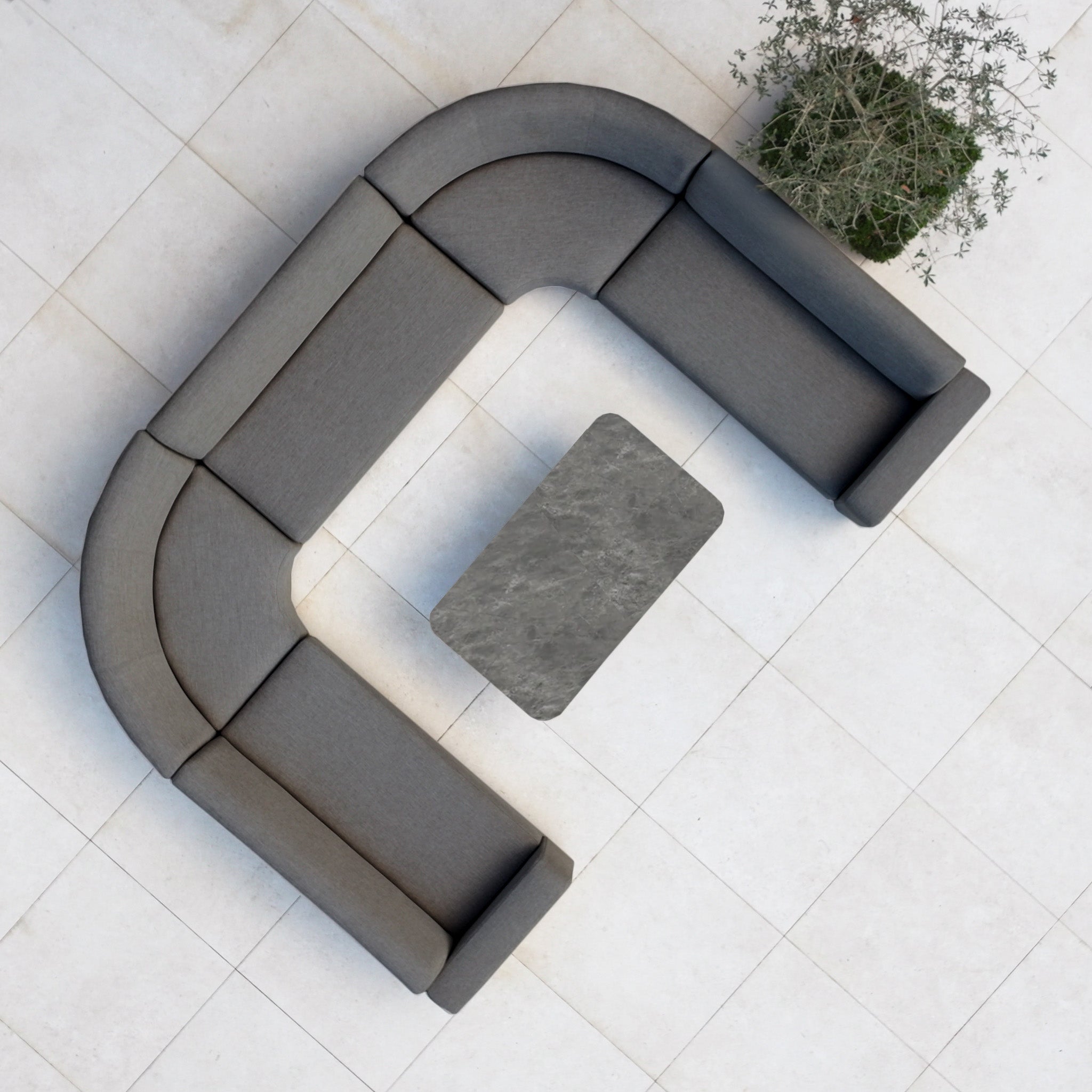 The Luna Outdoor Fabric Curved U-Shape Sofa Set with Altura Rising Table in Grey is a stylish all-weather addition for your garden, featuring a curved sofa and versatile table on a tiled floor with a nearby potted plant.