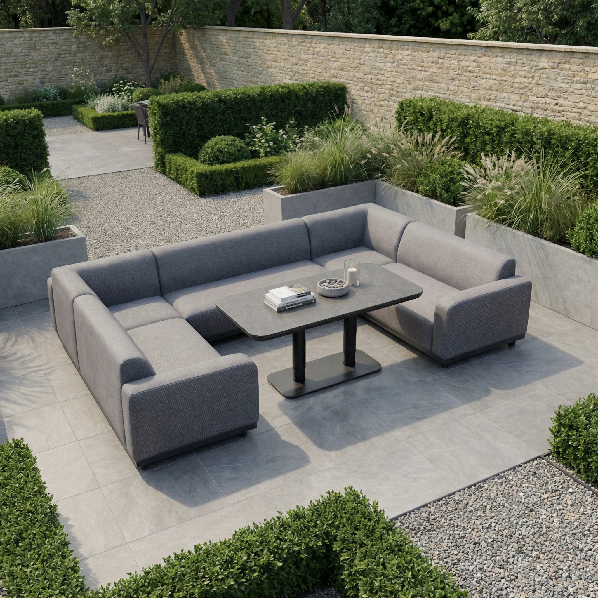 The Luna U-Shape Outdoor Fabric Sofa Set with Altura Rising Table in Grey features a durable aluminium frame and solution-dyed acrylic fabric, perfect for landscaped gardens with hedges and gravel paths.