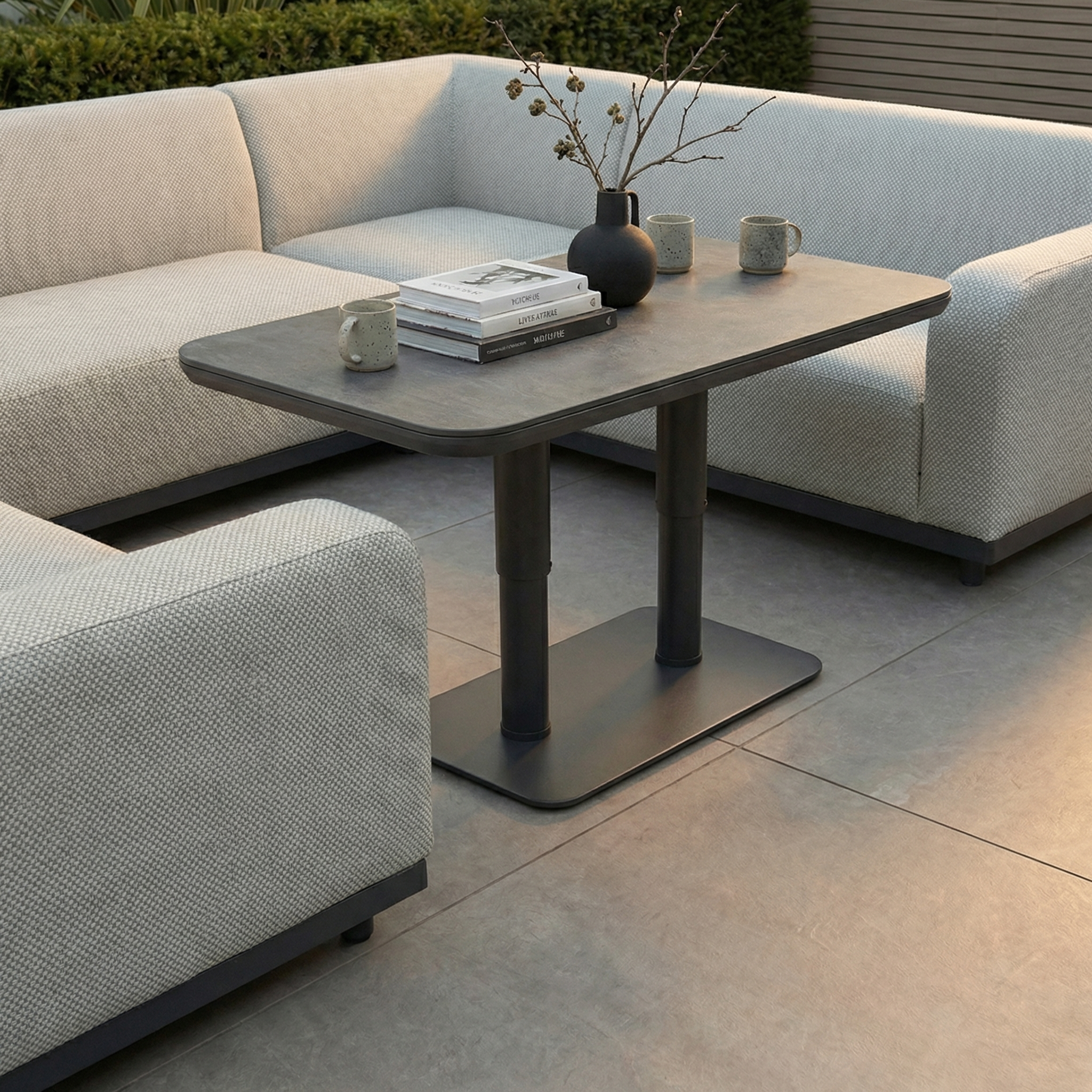 Create a stylish outdoor living space with the Luna U-Shape Outdoor Fabric Sofa Set in Oyster Grey and the Altura Rising Table—rain-resistant, modern comfort for your patio.