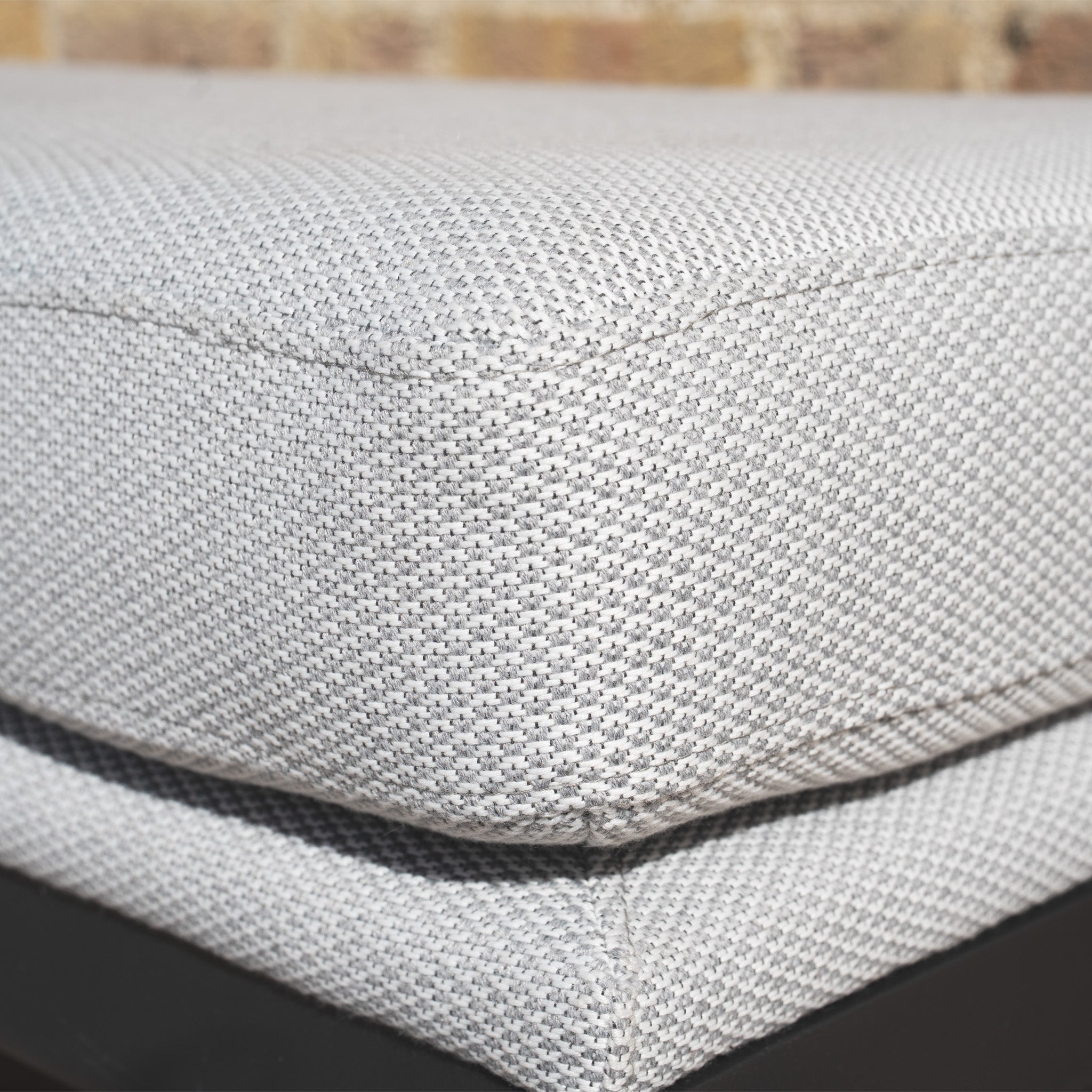 Close-up of the Luna Stool in Oyster Grey with textured quick-dry cushion and visible corner seam on a dark base, ideal for all-weather outdoor use.