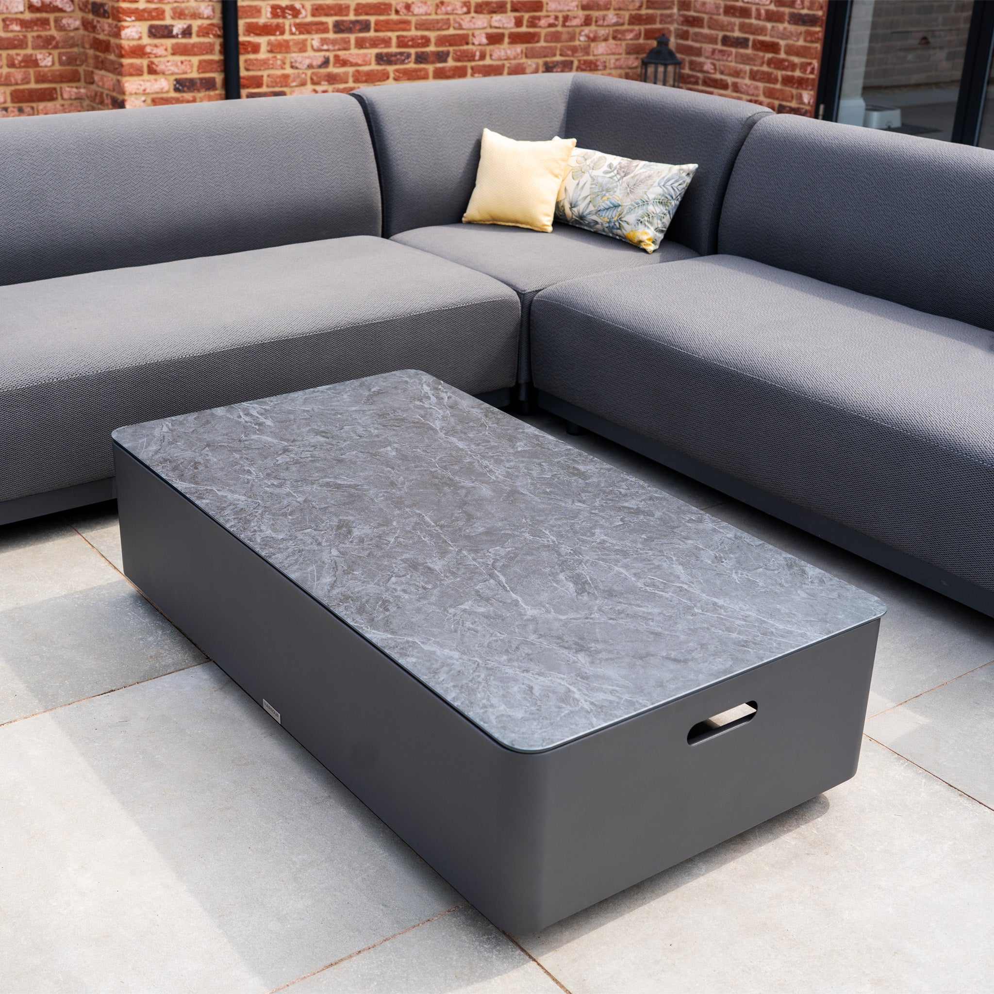 The Luna Outdoor Fabric Corner Sofa Set with Coffee Table in Grey features stain-proof fabric and a marble-top table, perfect for tiled patios.