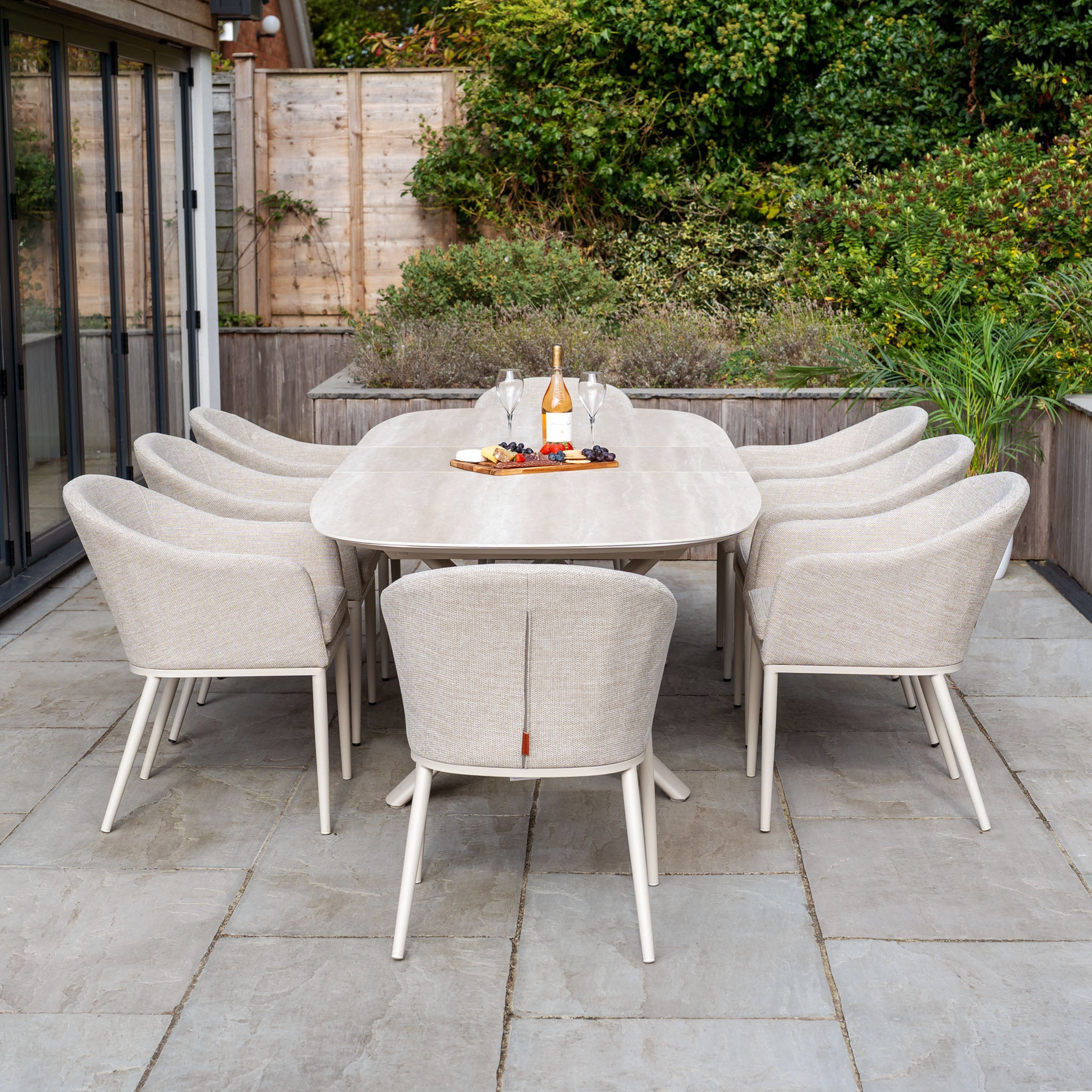 The Luna 8 Seat Outdoor Fabric Oval Dining Set with Albatross Extending Table in Fawn features eight chairs, UV-resistant cushions, and a spacious extending table, perfect for stylish patio dining.