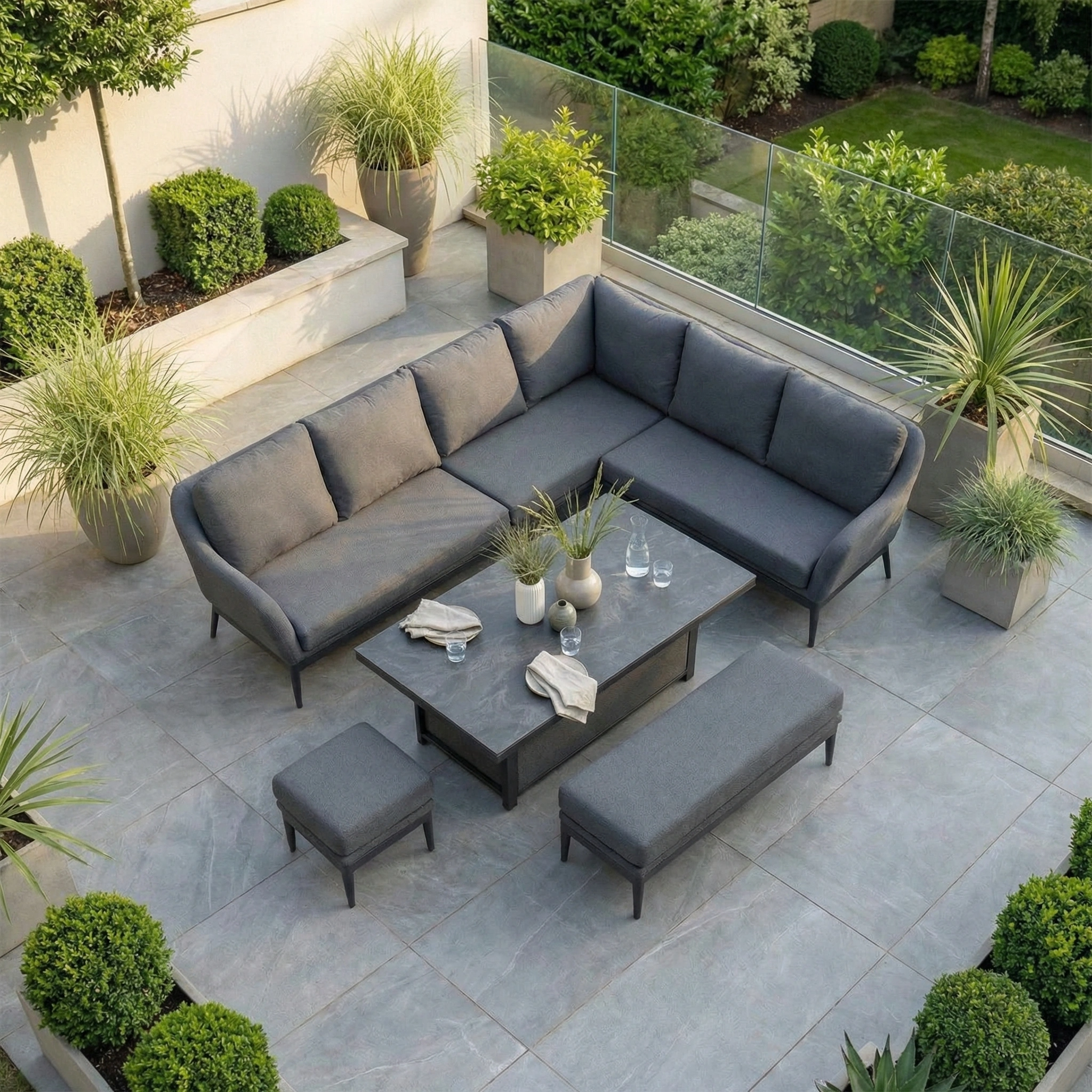 The modern outdoor patio features the Luna Outdoor Fabric Rectangular Corner Dining Set with Rising Table in Grey (Right Hand), offering a stylish gray sectional, benches, and all-weather comfort year-round.