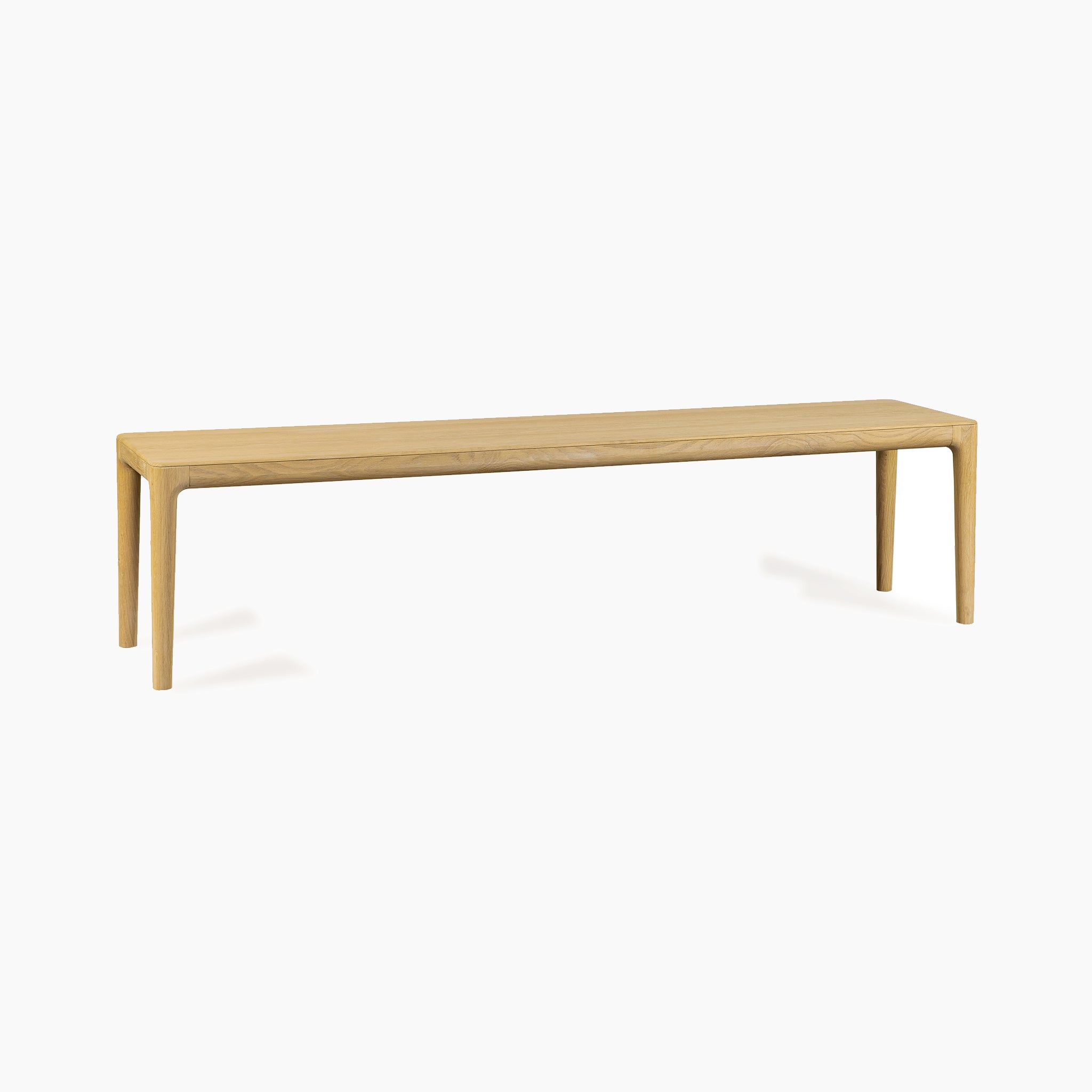 The Marlow Dining Wooden Bench in Light Oak features four legs and smooth edges, crafted from solid wood and displayed against a plain white background with a minimalist design.