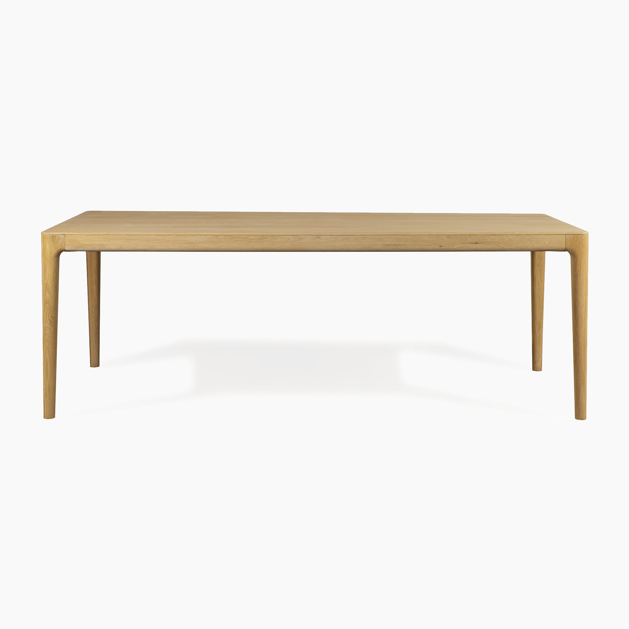 The Marlow 8 Seat Dining Set features a rectangular solid light oak table with four slender legs, paired with matching wooden benches. Shown against a plain white background.