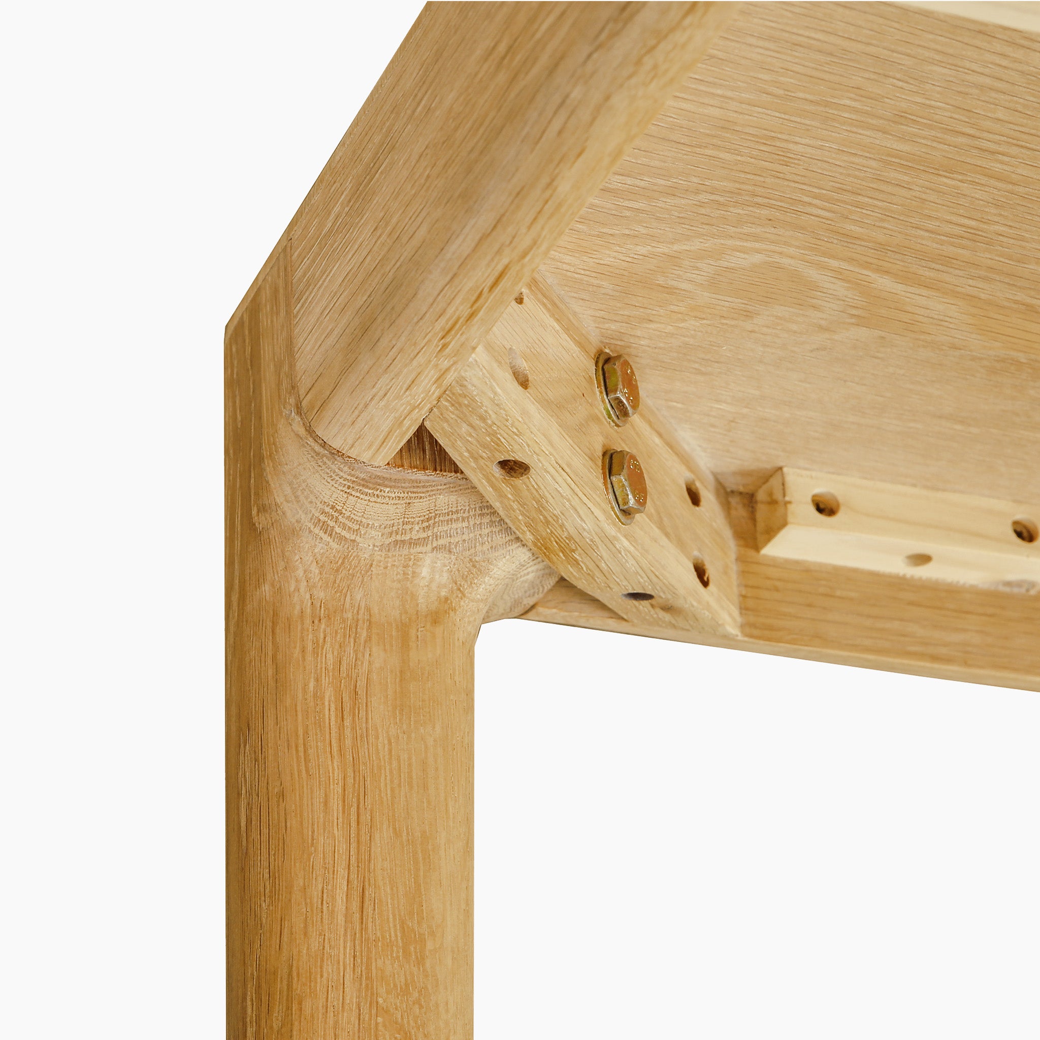 Close-up of a solid light oak joint with bolts, highlighting detailed craftsmanship and angled assembly—ideal for complementing the Marlow 8 Seat Dining Set with Wooden Benches in Light Oak.