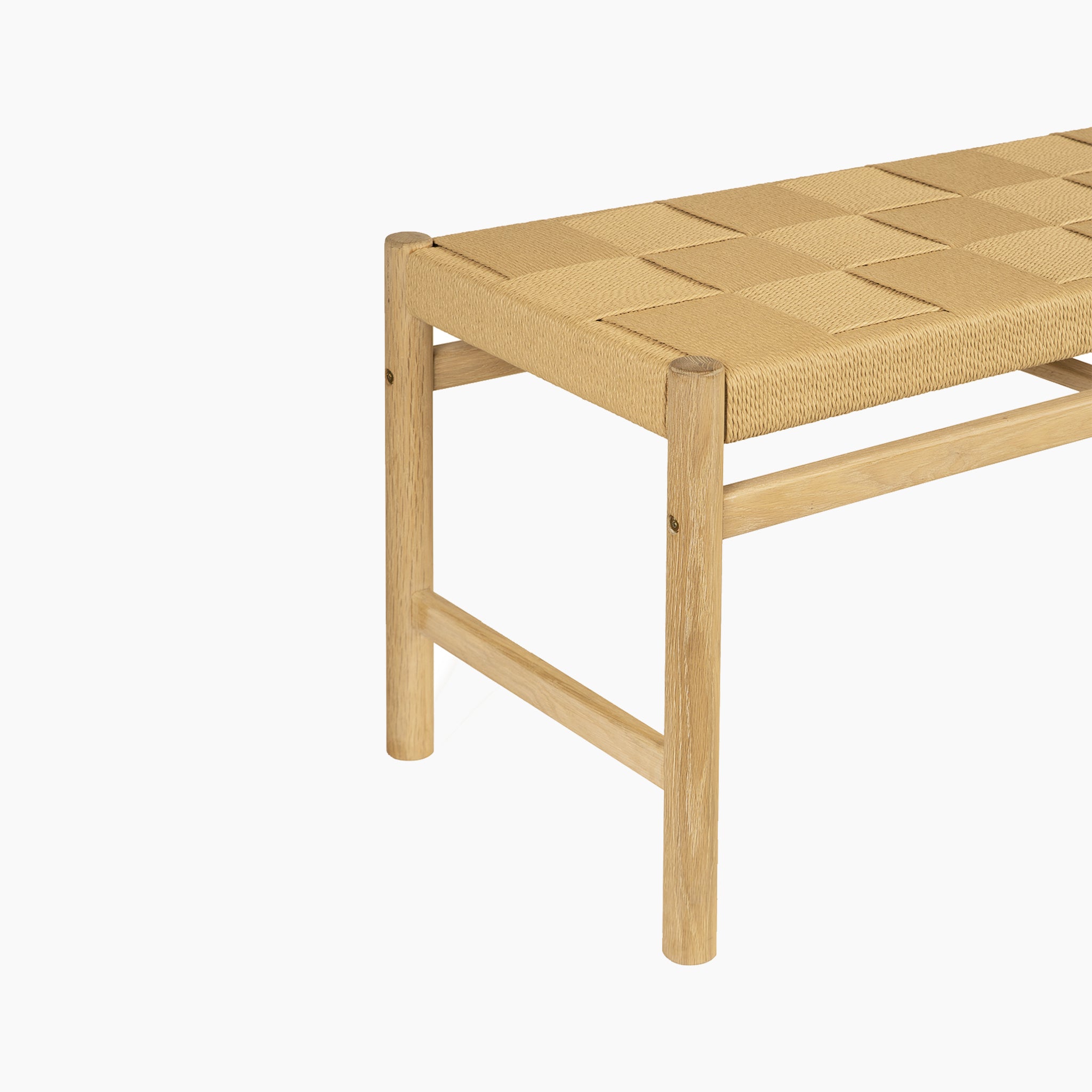 The Marlow 8 Seat Dining Set with Woven Bench in Light Oak features a wooden bench with a cane seat, shown angled against a white background. Complements the Marlow set or pairs well with any solid oak dining table.