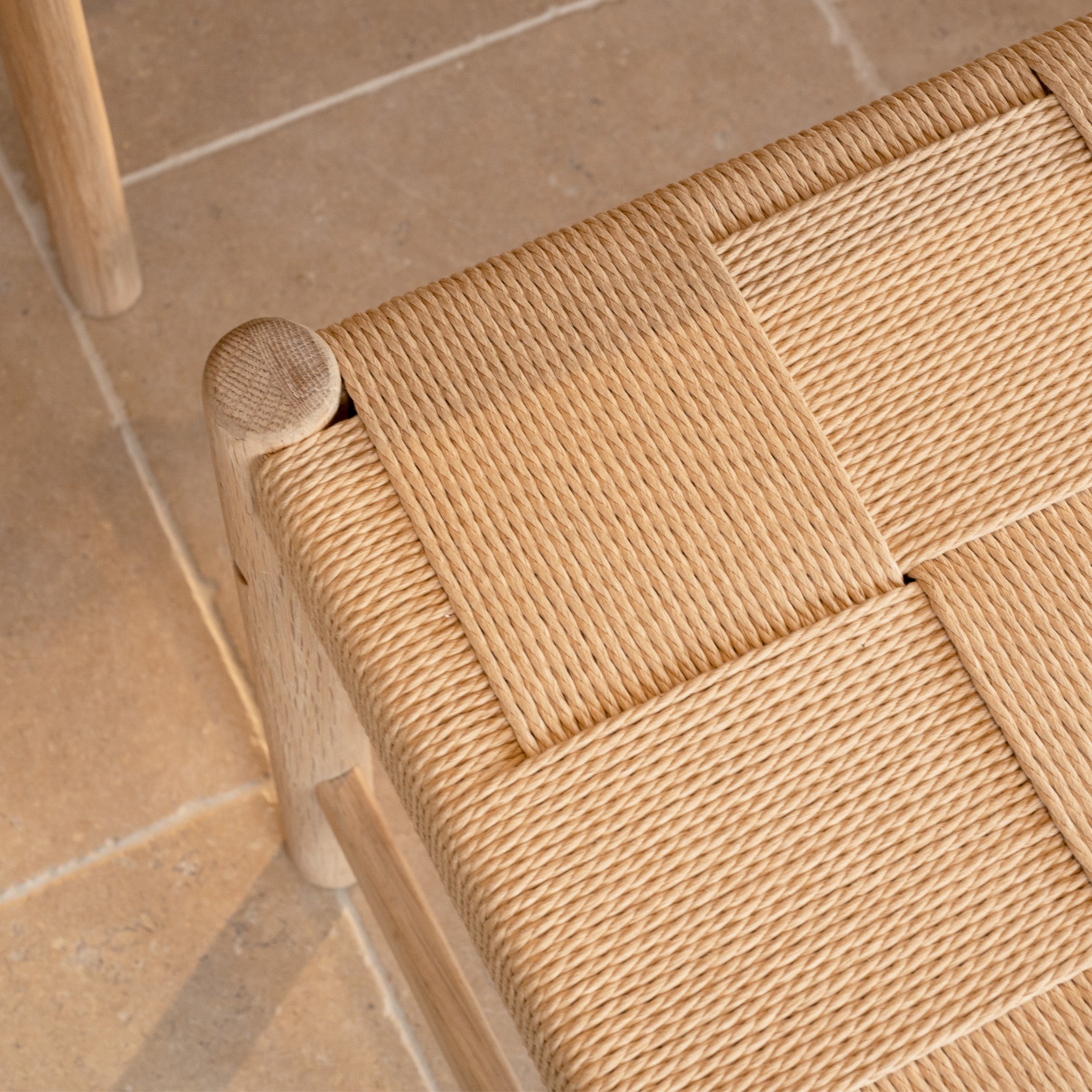 Close-up of a woven wooden chair seat with a light checkerboard pattern, perfectly complementing the Marlow 8 Seat Dining Set with Woven Bench in Light Oak or paired with a solid oak dining table.