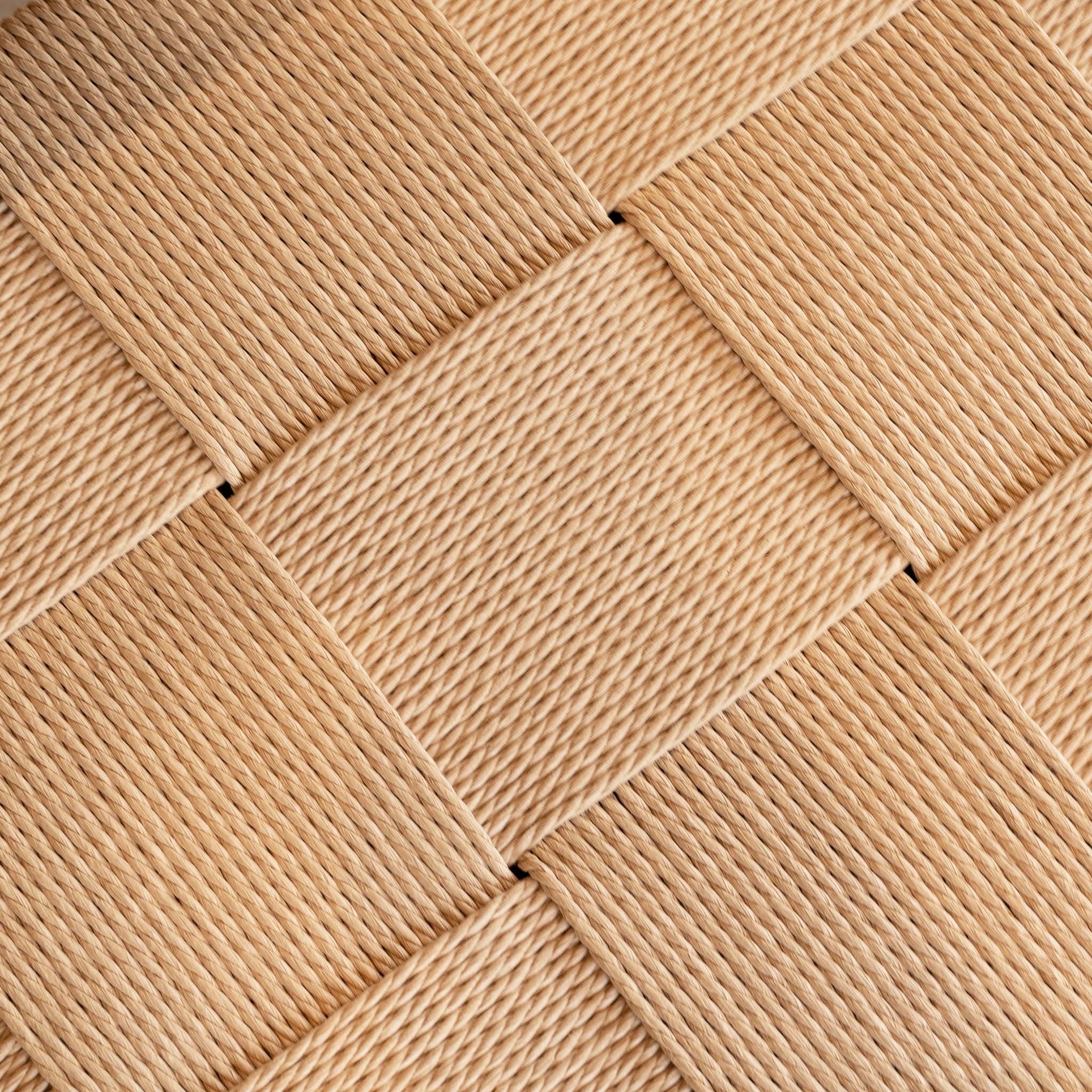 Close-up of a light tan, textured checkerboard weave—ideal for pairing with the woven bench in the Marlow 8 Seat Dining Set with Woven Bench in Light Oak.