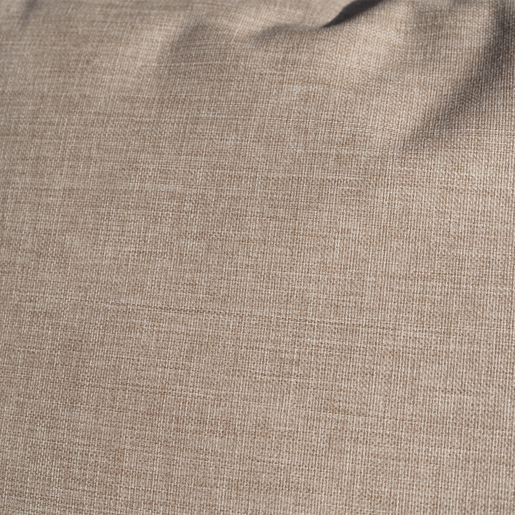Close-up of beige fabric with a subtle woven texture, echoing the rope-weave backrest of the Quay Corner Sofa Dining Set in Mocha, and featuring slight creases near the top.