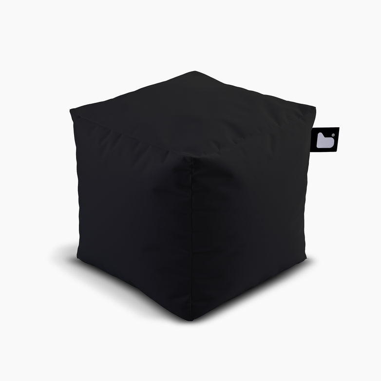 The Outdoor B-Box in Black is a square bean bag with a small tag featuring a heart and duck icon, designed for extreme lounging. It is waterproof and set against a plain white background.