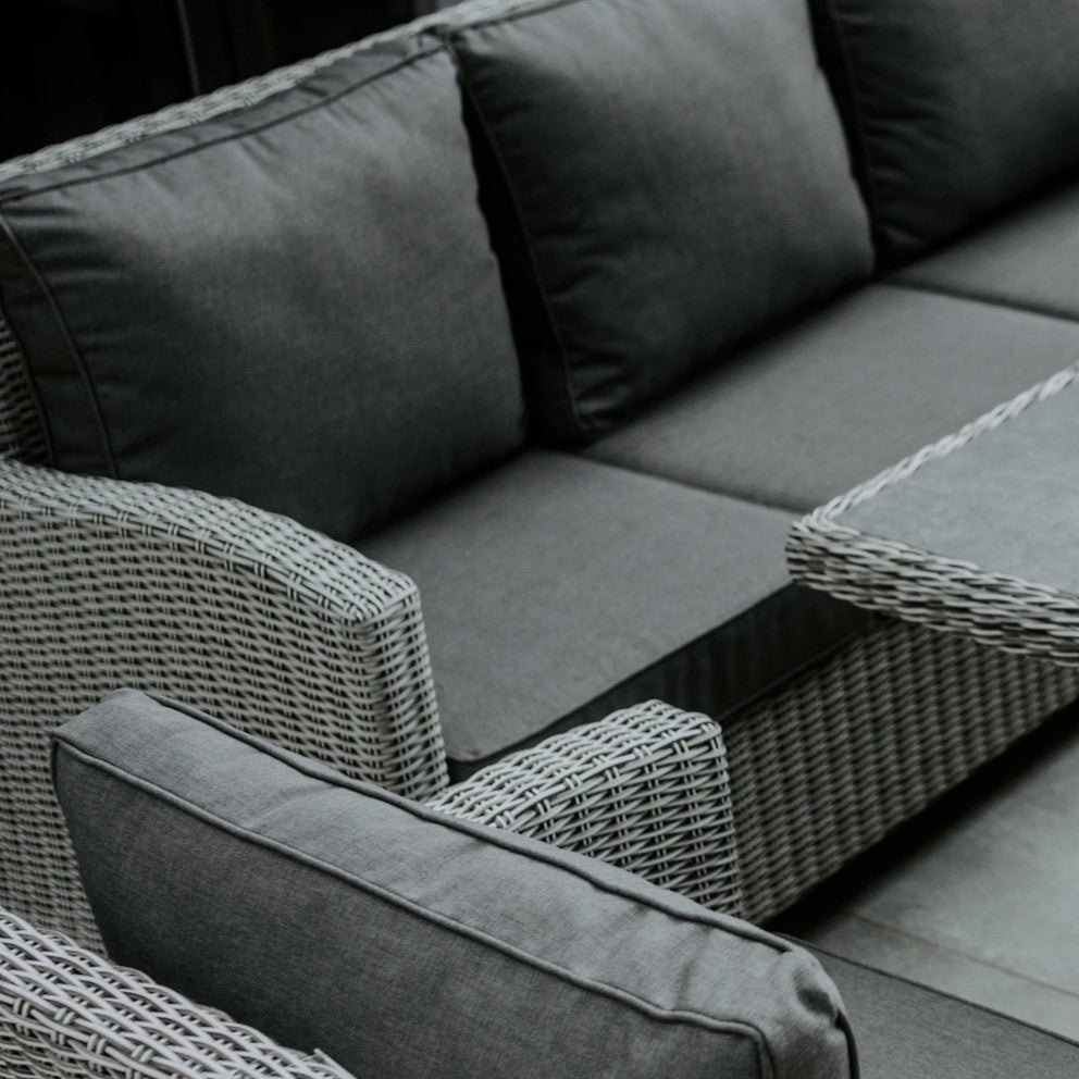 The Santiago 3 Seat Sofa and Bench in white wash features armrests, dark gray cushions, and a matching coffee table—a perfect addition to your aluminium garden furniture or a stylish alternative to a rattan bench.