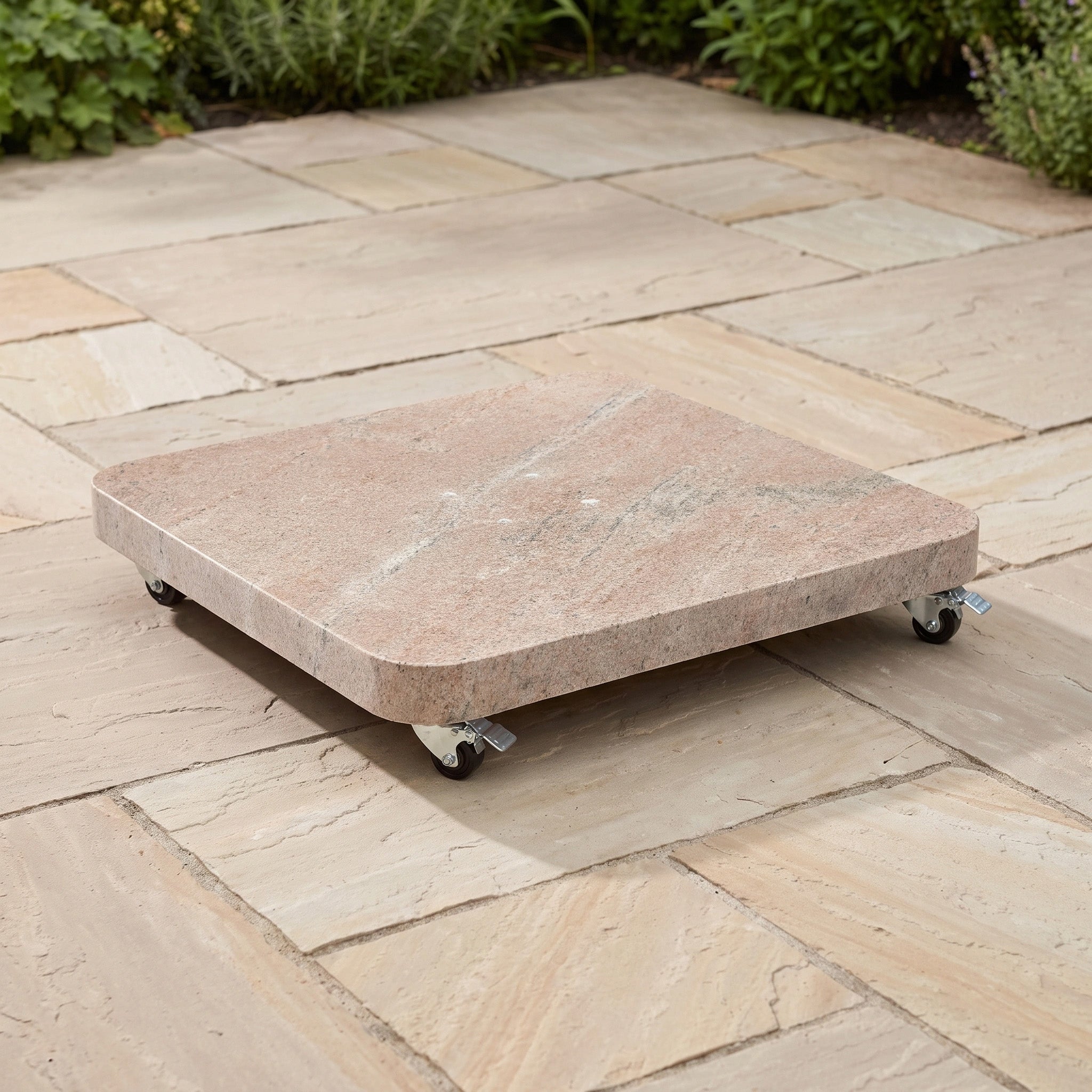 The Nexus T2 Premium 3m Square Cantilever Parasol in Deep Taupe, anchored by the sturdy Venezia 90kg Granite Base, sits on a paved patio surrounded by greenery, providing robust support for contemporary outdoor settings.