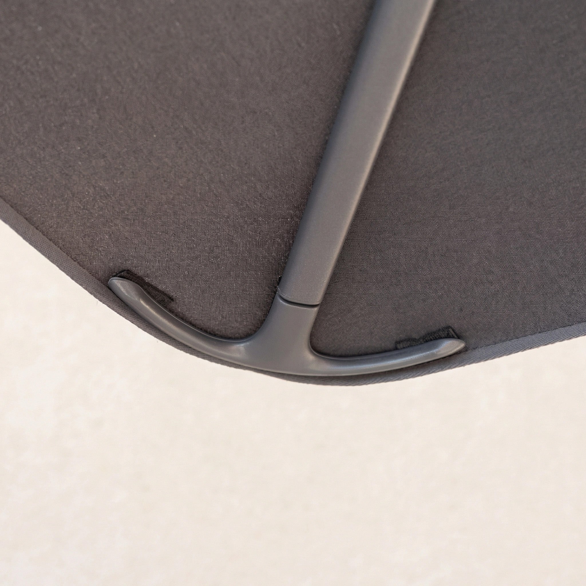 Close-up of the Nexus T2 Premium 3m Square Cantilever Parasol in Black with its fabric and rib details, shown against a light, neutral background. Includes 90kg granite base.