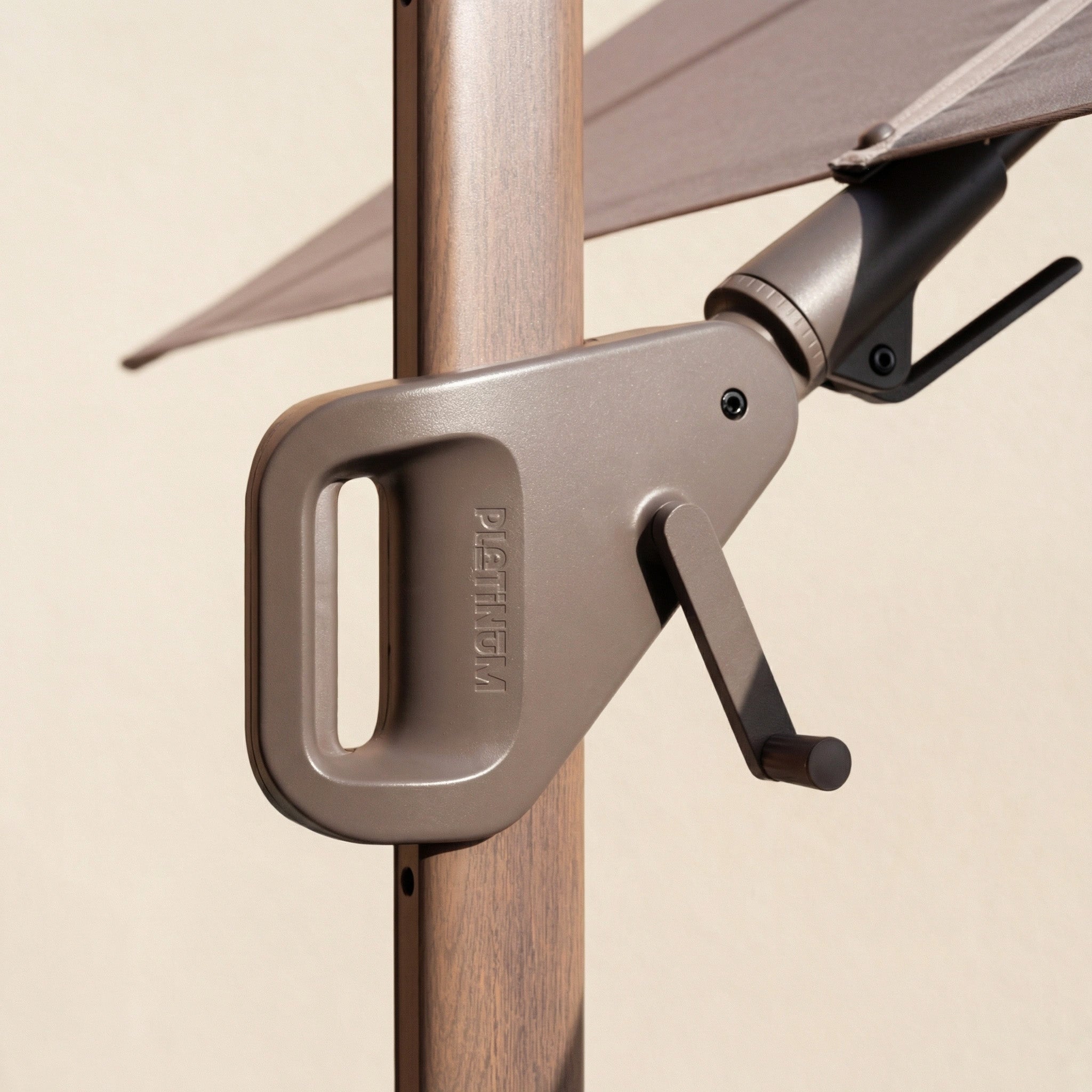 Close-up of the Nexus T2 Premium 3m Square Cantilever Parasol in Deep Taupe with 90kg Granite Base, featuring a crank handle on a wooden pole—ideal for enhancing your garden furniture, shown against a neutral background.