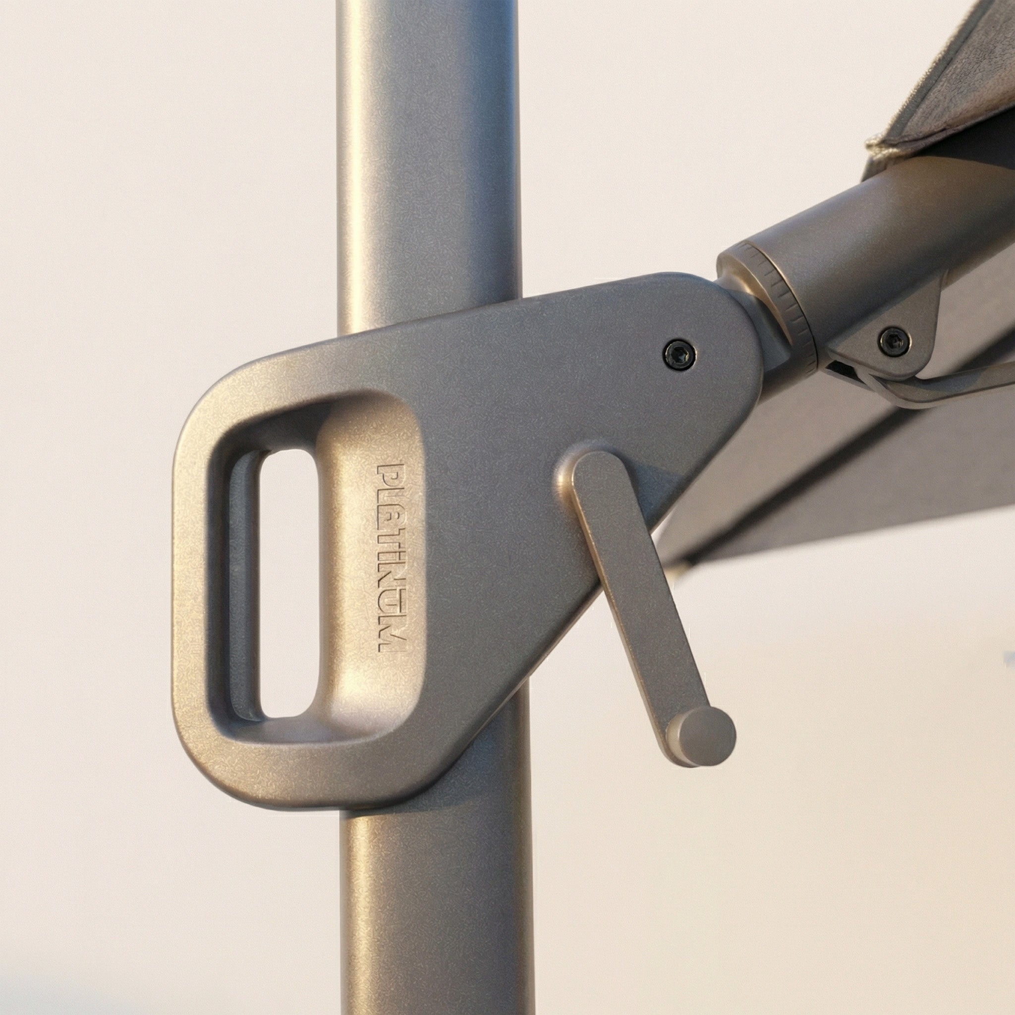 Close-up of the metal crank handle on the Nexus T2 Premium 3m Square Cantilever Parasol in Manhattan Grey with 90kg Granite Base, designed for smooth 360-degree rotation and easy adjustment.