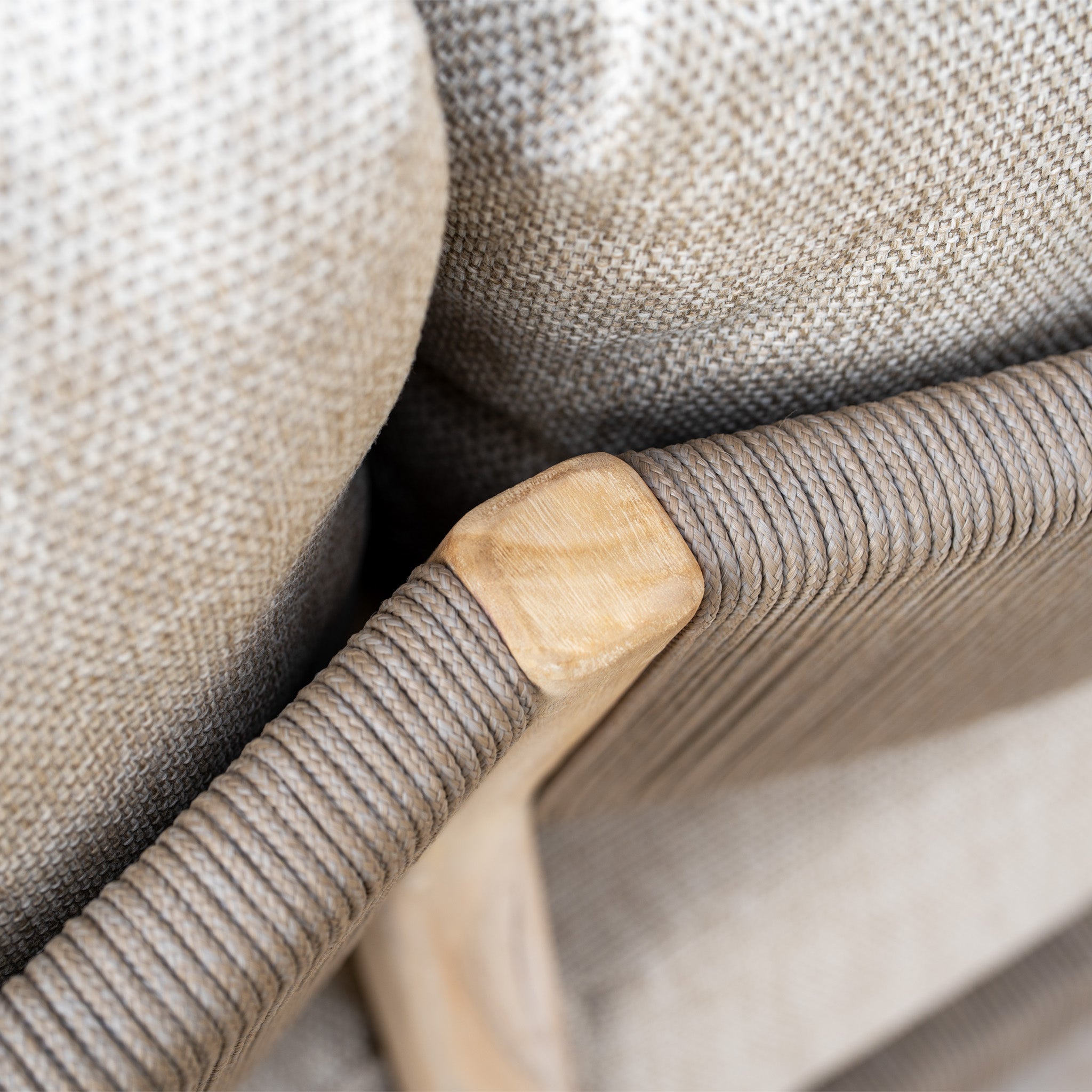Close-up of a beige woven chair frame with textured cushions and a wooden corner detail, part of the Noah Corner Sofa Set in Volga Grey—ideal for elevating your garden space or pairing with teak outdoor furniture.