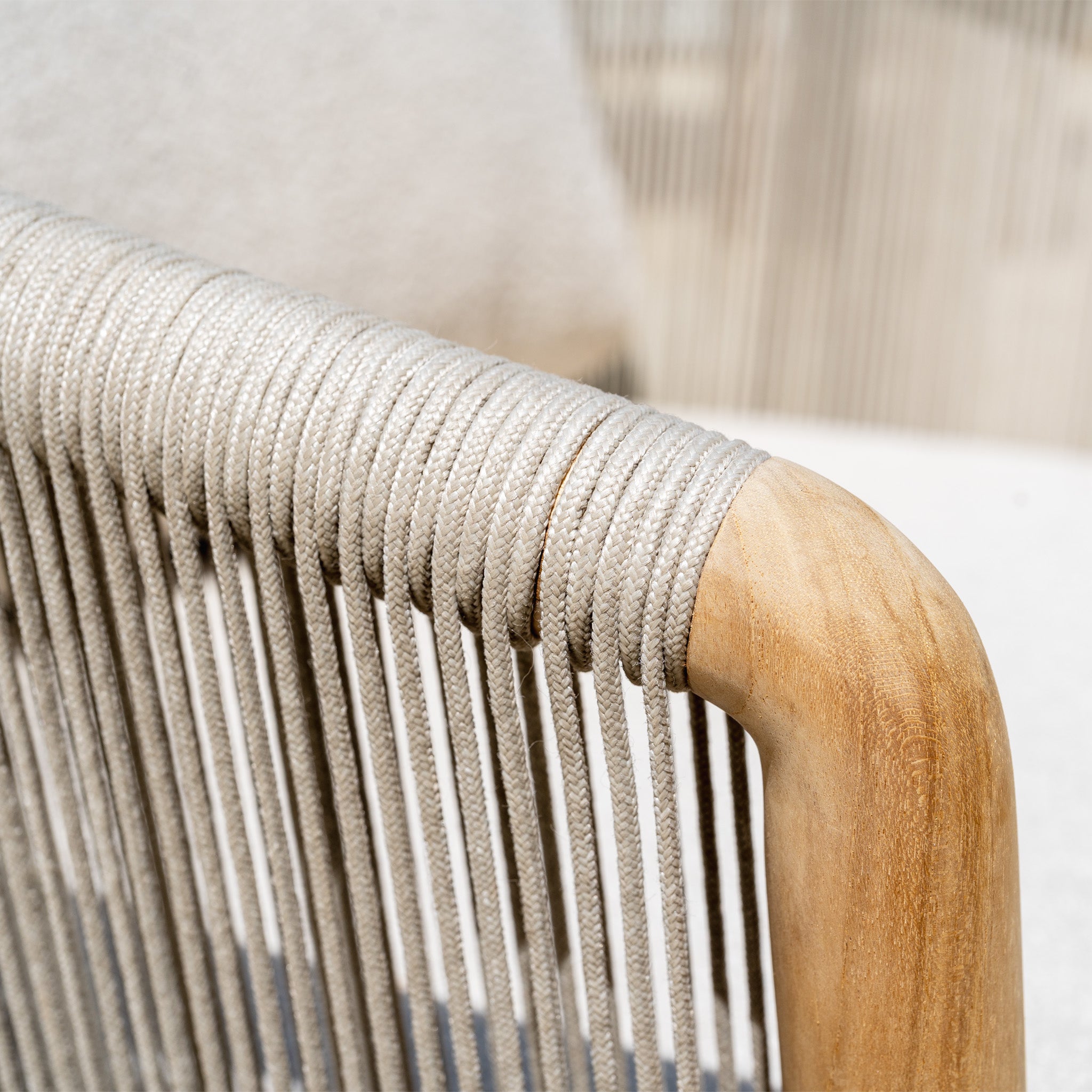 Close-up of a wooden chair armrest wrapped in tightly woven light gray rope, highlighting the weather-resistant detail featured on the New York 3 Seat Sofa Set.