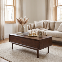 A cozy living room with a beige sofa, an Oslo Coffee Table with 4 Drawers in Walnut, and neutral decor on a textured rug.