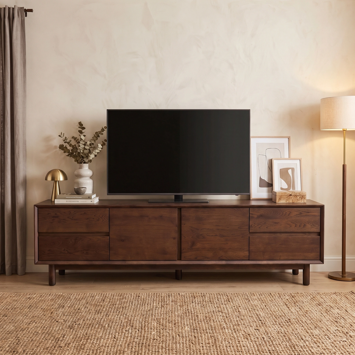 Oslo TV Unit in Walnut with a flat-screen TV, decor, lamp, framed art, and a rug in a cozy living room.