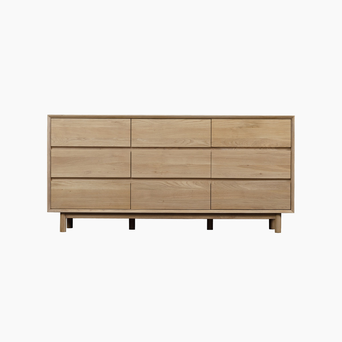 Oslo 9 Drawer Chest in Light Oak features a minimalist design with nine spacious drawers and a rectangular shape on short legs—capturing the timeless charm of solid wood furniture, it’s perfect for modern interiors.