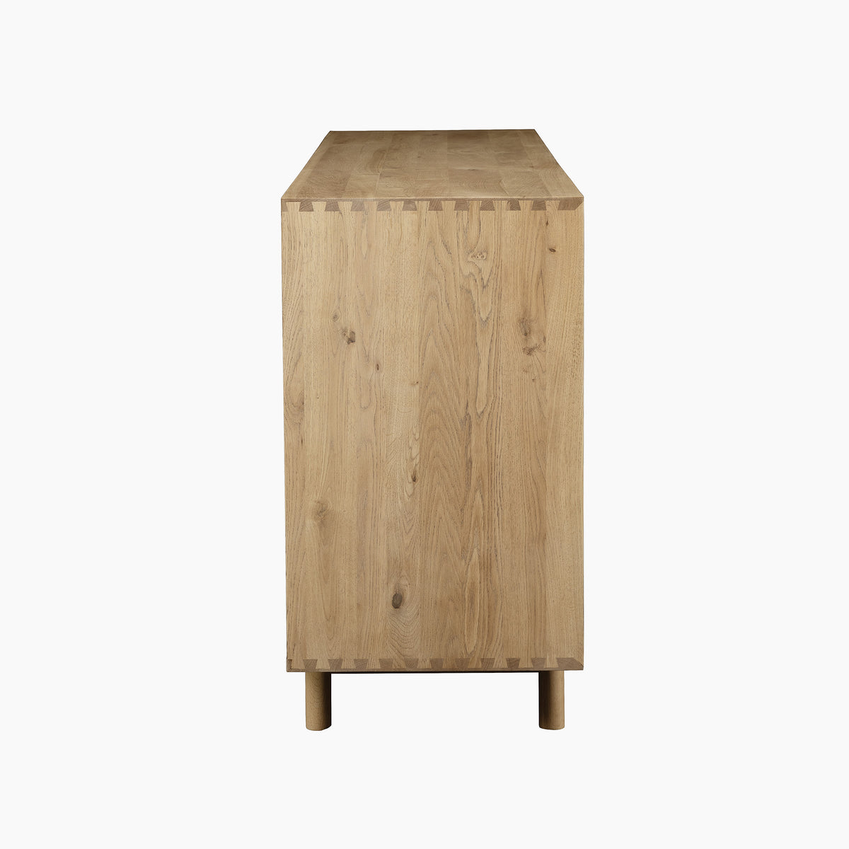 Side view of the Oslo Grand 4 Door Sideboard with Wine Rack in Light Oak, showcasing visible dovetail joints and simple cylindrical legs. The sideboard’s clean lines and craftsmanship are enhanced by a discreet built-in wine rack for added functionality.
