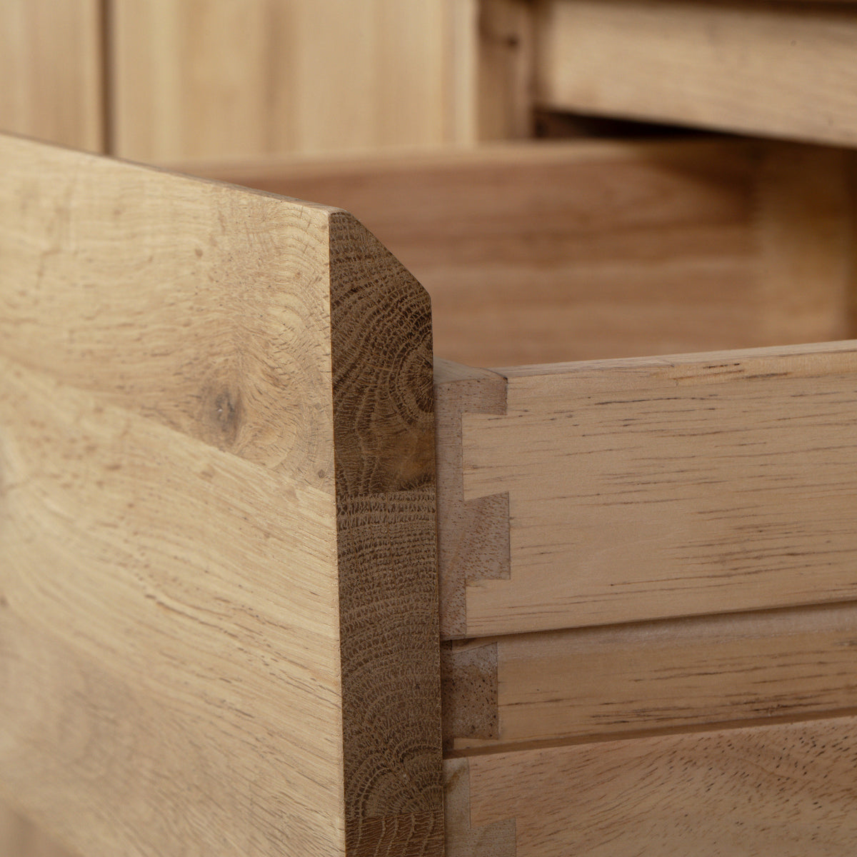 Close-up of a wooden drawer with dovetail joints, partially opened in the Oslo TV Unit in Light Oak—a solid oak media cabinet perfect for modern living room furniture.