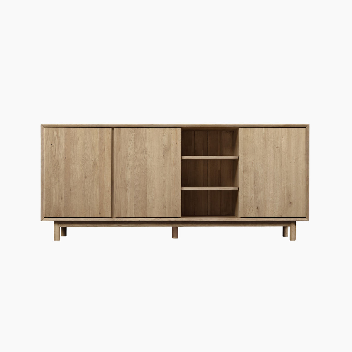 The Oslo 3 Door Sideboard with Shelves in Light Oak showcases a contemporary design with two closed cabinets and three open shelves, set on short legs, making it a stylish and versatile storage solution for any modern living space. Displayed here against a white background.