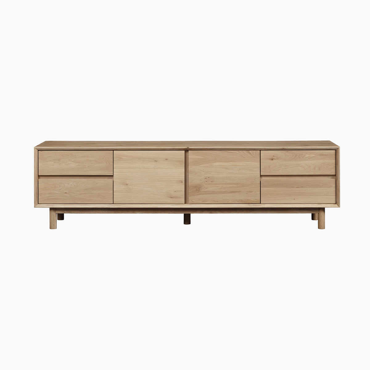 Experience modern living room furniture at its finest with the Oslo TV Unit in Light Oak—a stylish solid oak TV stand featuring two sliding doors and four drawers for exceptional functionality. Set against a clean white background, this sleek media cabinet serves as an elegant centerpiece for any contemporary home.