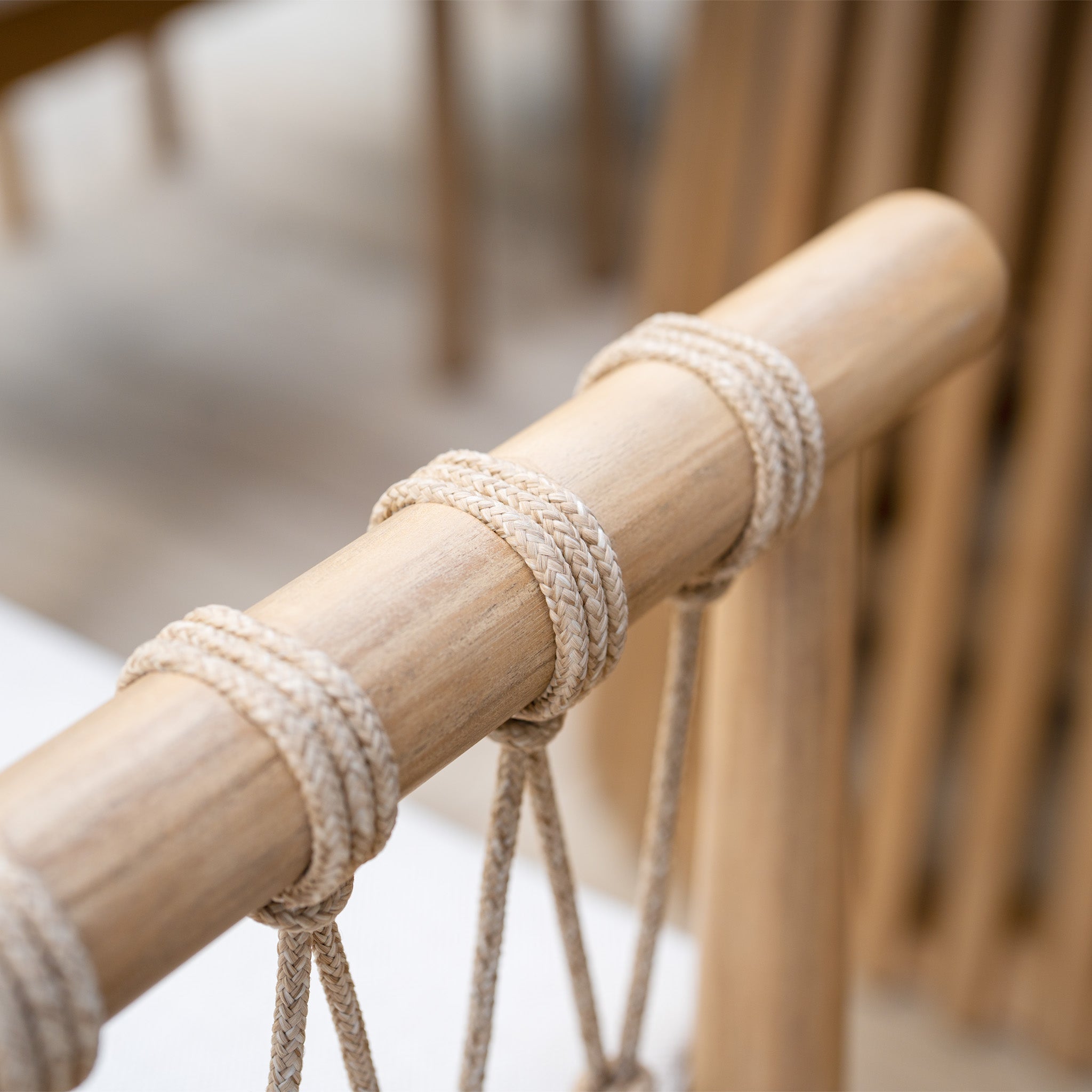 This close-up captures a chair from the Paia 8 Seat Rectangular Dining Set in Linen, featuring intricate rope detailing on the backrest, crafted from durable Acacia wood, perfect for outdoor dining.