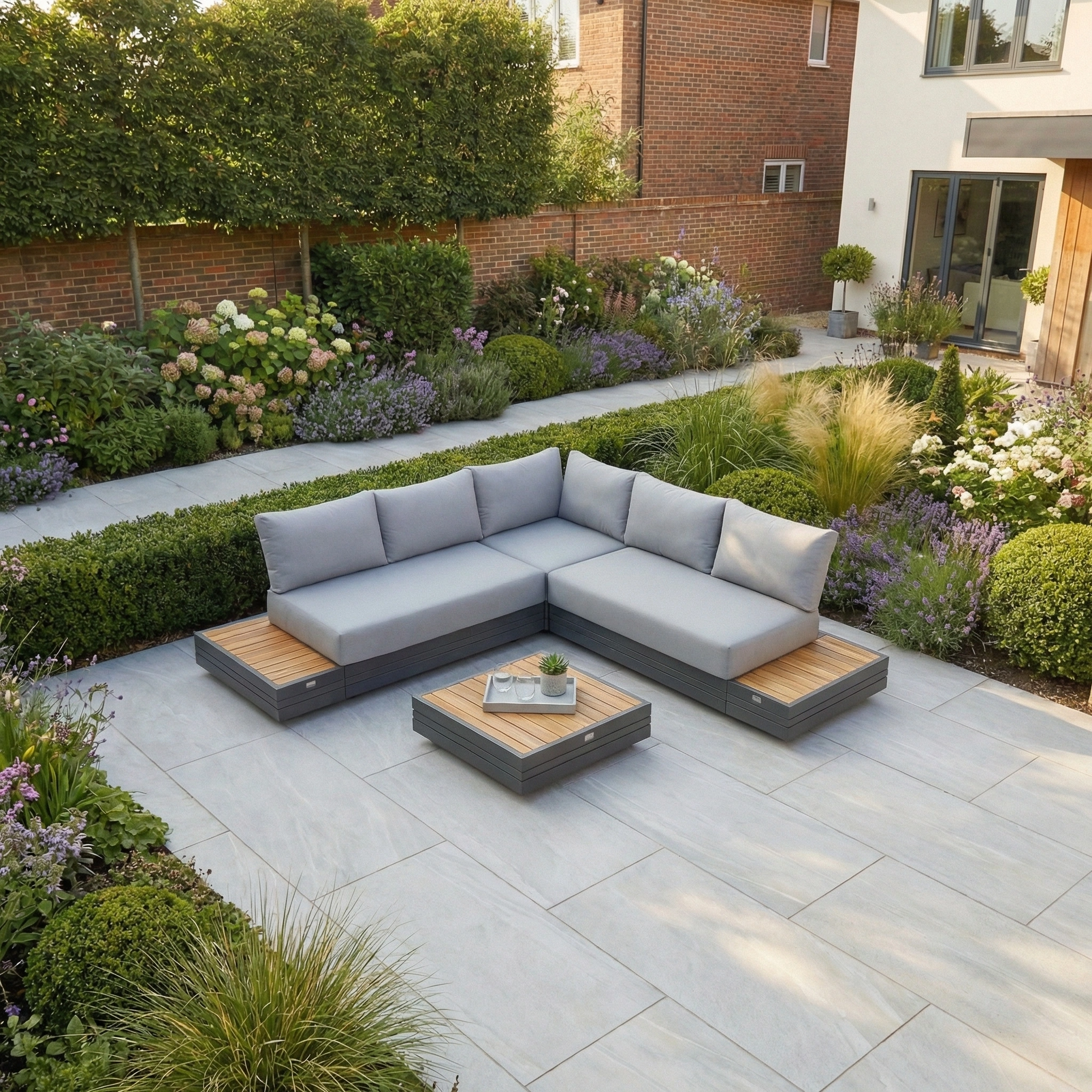 The Panama Luxury Outdoor Corner Group Set in Washed Grey transforms your stone patio, surrounded by lush garden beds, into a perfect relaxation spot. Pair with sustainable teak furniture for timeless style.