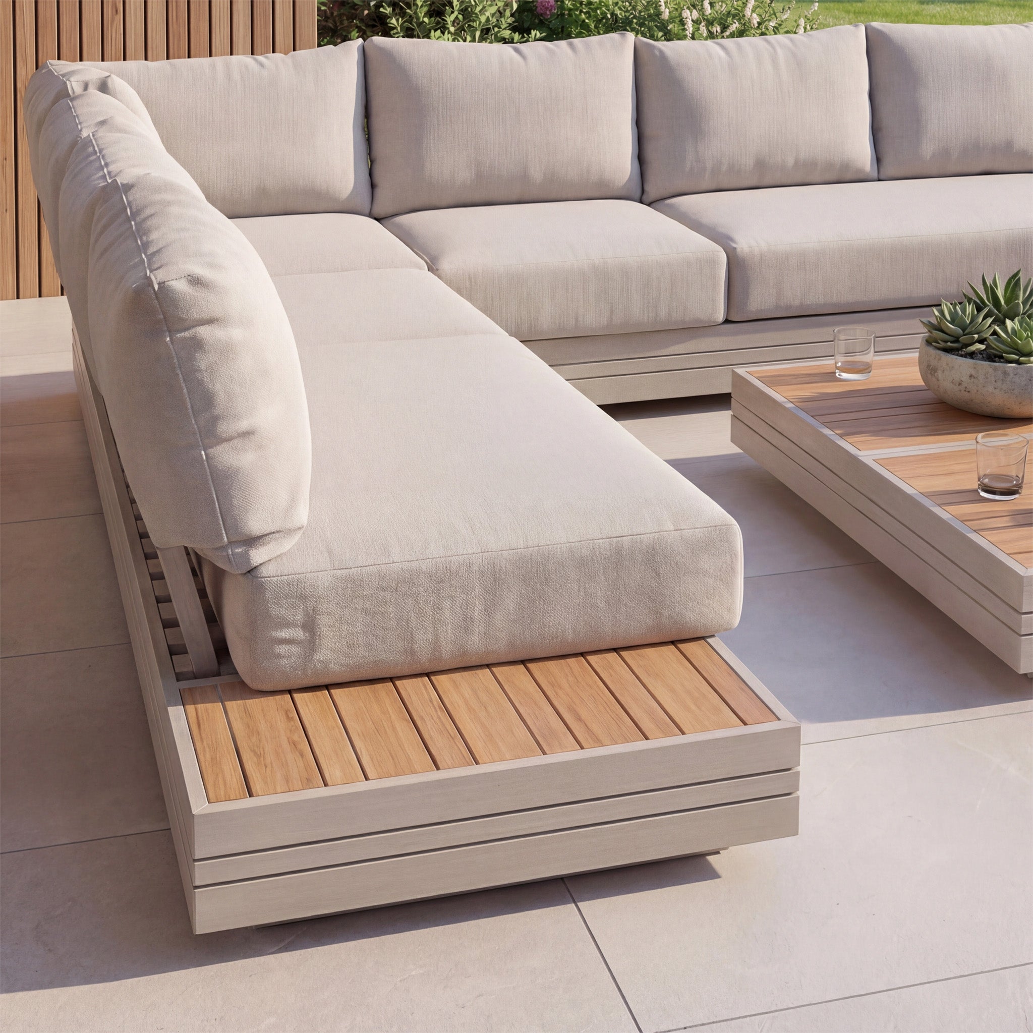 The Panama Luxury Outdoor Large U-Shape Corner Sofa Set in Latte features beige cushions, elegant wooden surfaces, and a matching teak coffee table for stylish outdoor comfort.