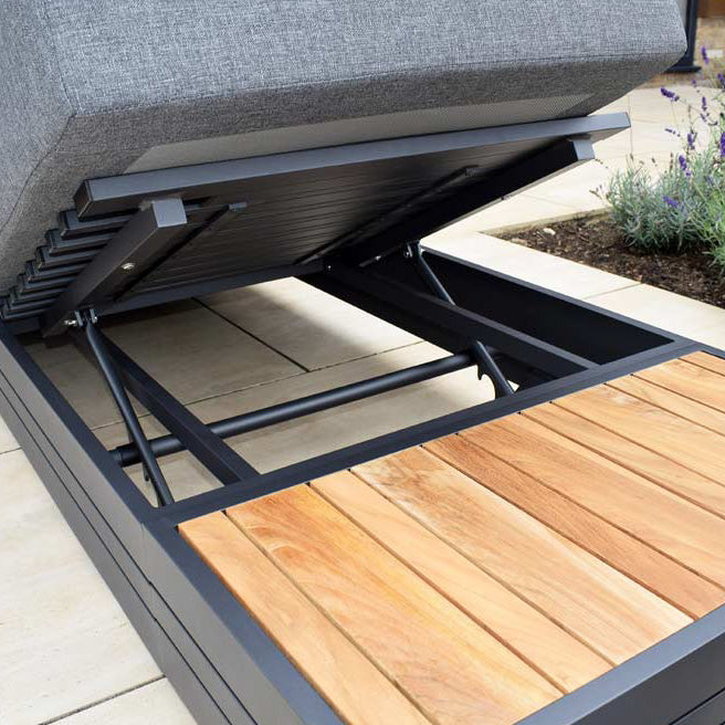 Close-up of an outdoor bench with a lifted seat revealing storage on a patio, complemented by the Panama Teak Side Table for stylish and functional outdoor furniture.