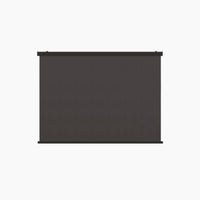 A large, blank black movie projector screen with a sleek grey finish, the 1x - 4M Integrated Manual Side Blind in Grey, stands against a white background.