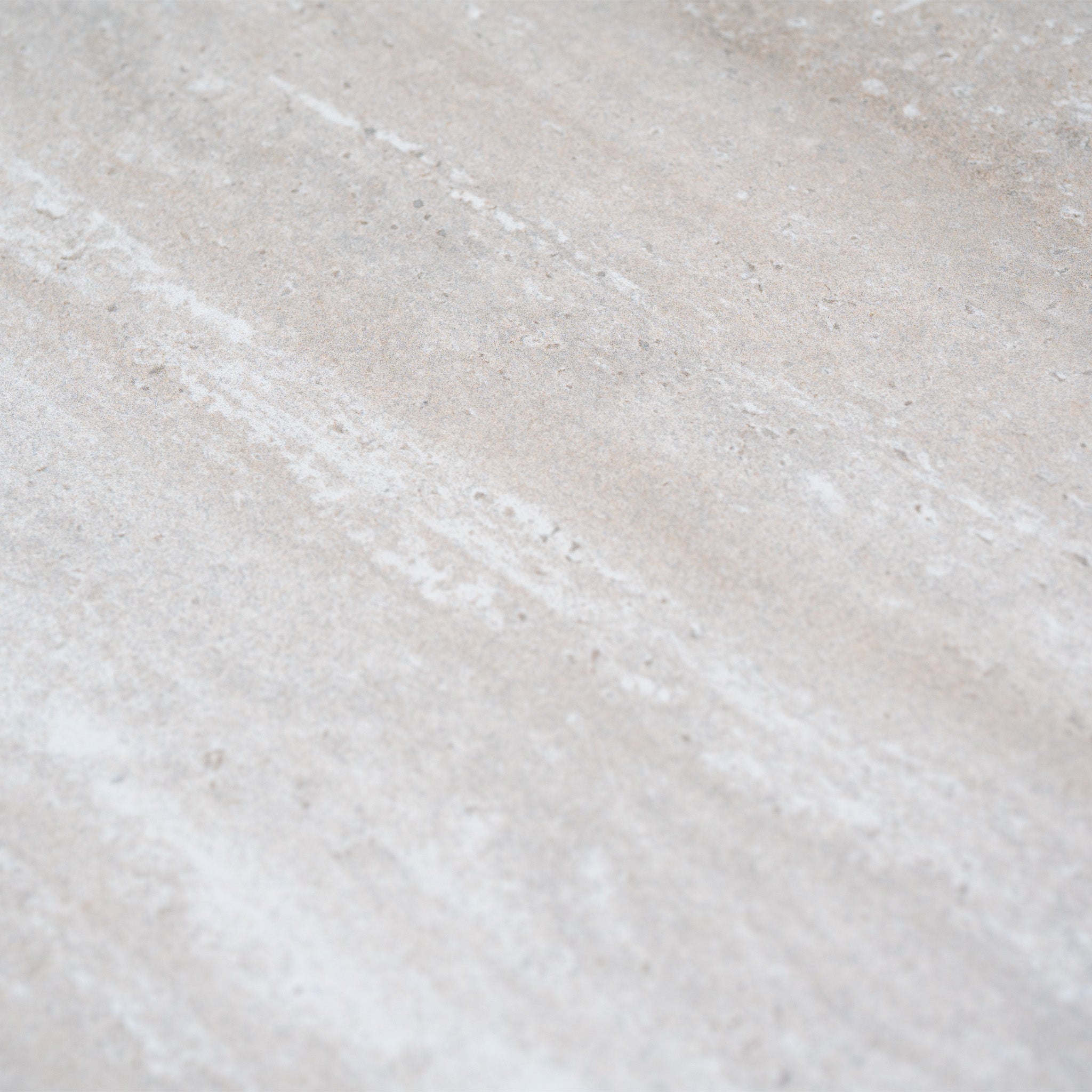 Close-up of a light beige stone surface with subtle white streaks and natural texture, ideal for the Pello 4 Seat Round Dining Set with Albatross Table in Fawn.