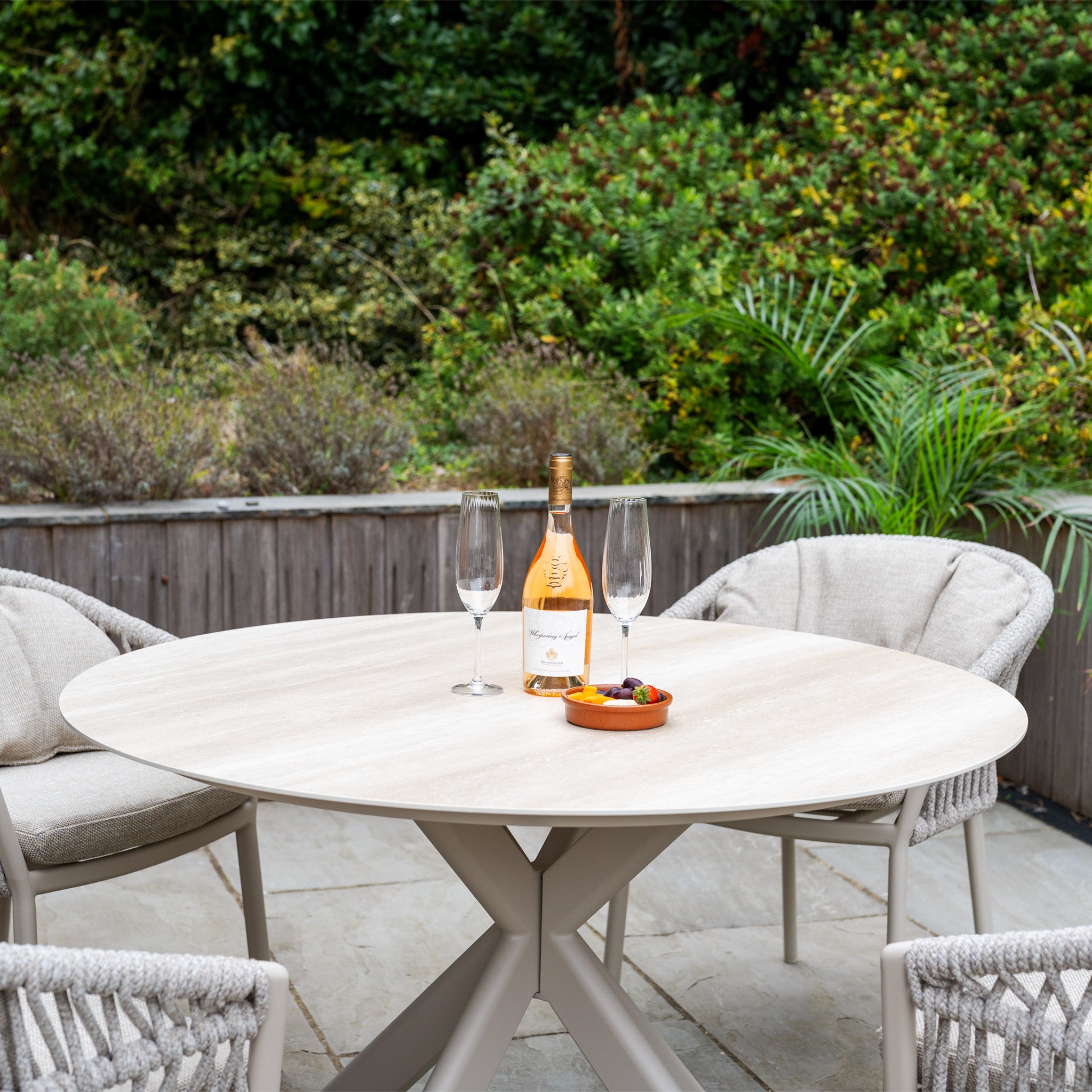 The Pello 4 Seat Round Dining Set with Albatross Table in Fawn offers stylish outdoor dining, combining comfort and elegance—ideal for enjoying meals surrounded by nature.