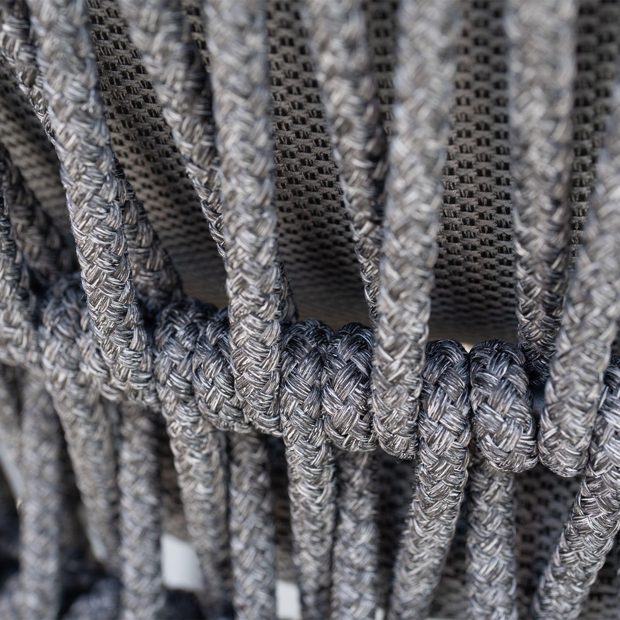 Close-up of woven gray rope with a braided pattern, featured on the Pello 8 Seat Dining Set with Albatross Extending Table in Grey.