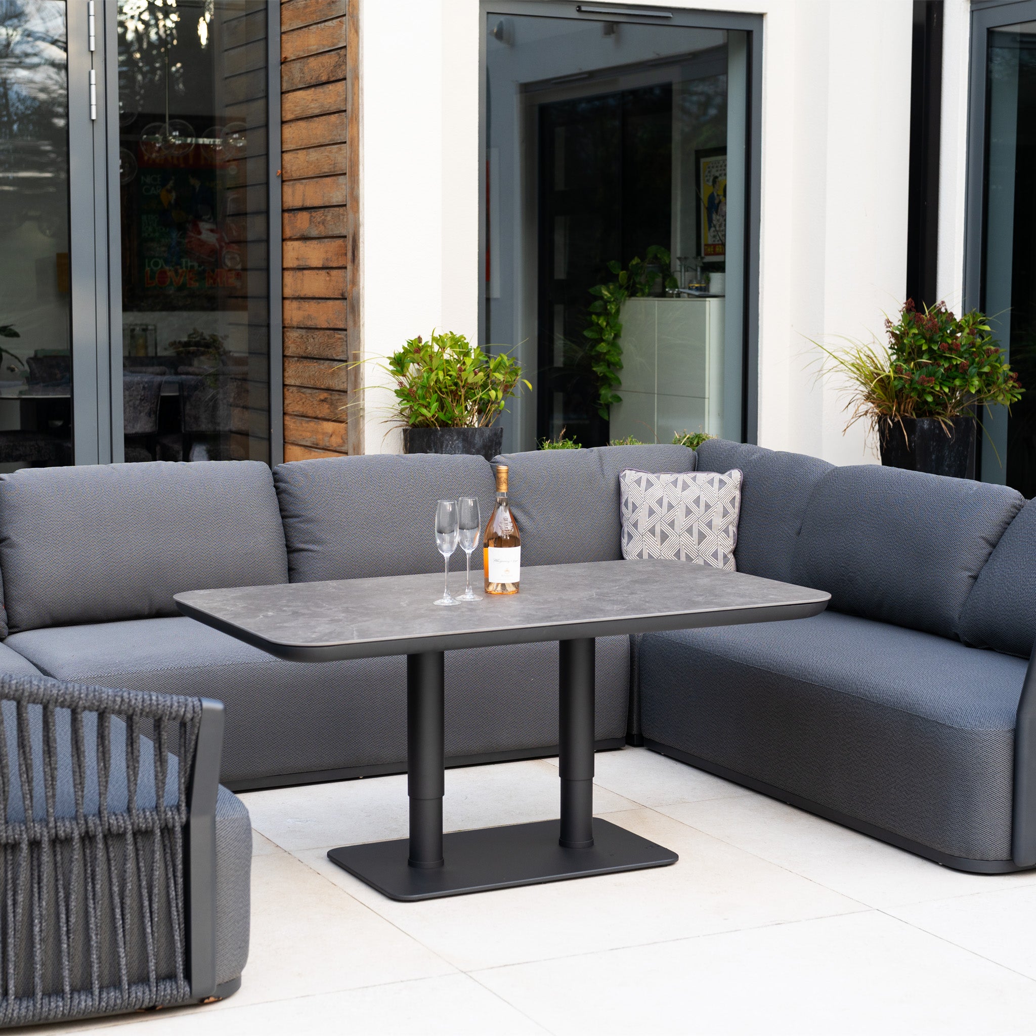 Relax or entertain in style with the Pello U-Shape Corner Sofa Set and Altura Rising Table in Grey—this modern garden furniture set is perfect for your outdoor patio.